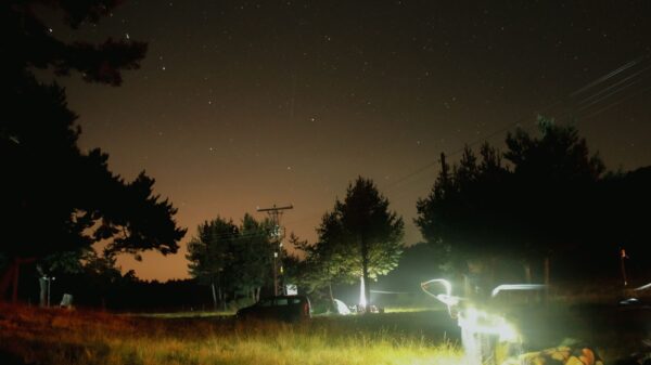 A campsite lit up under a starry sky