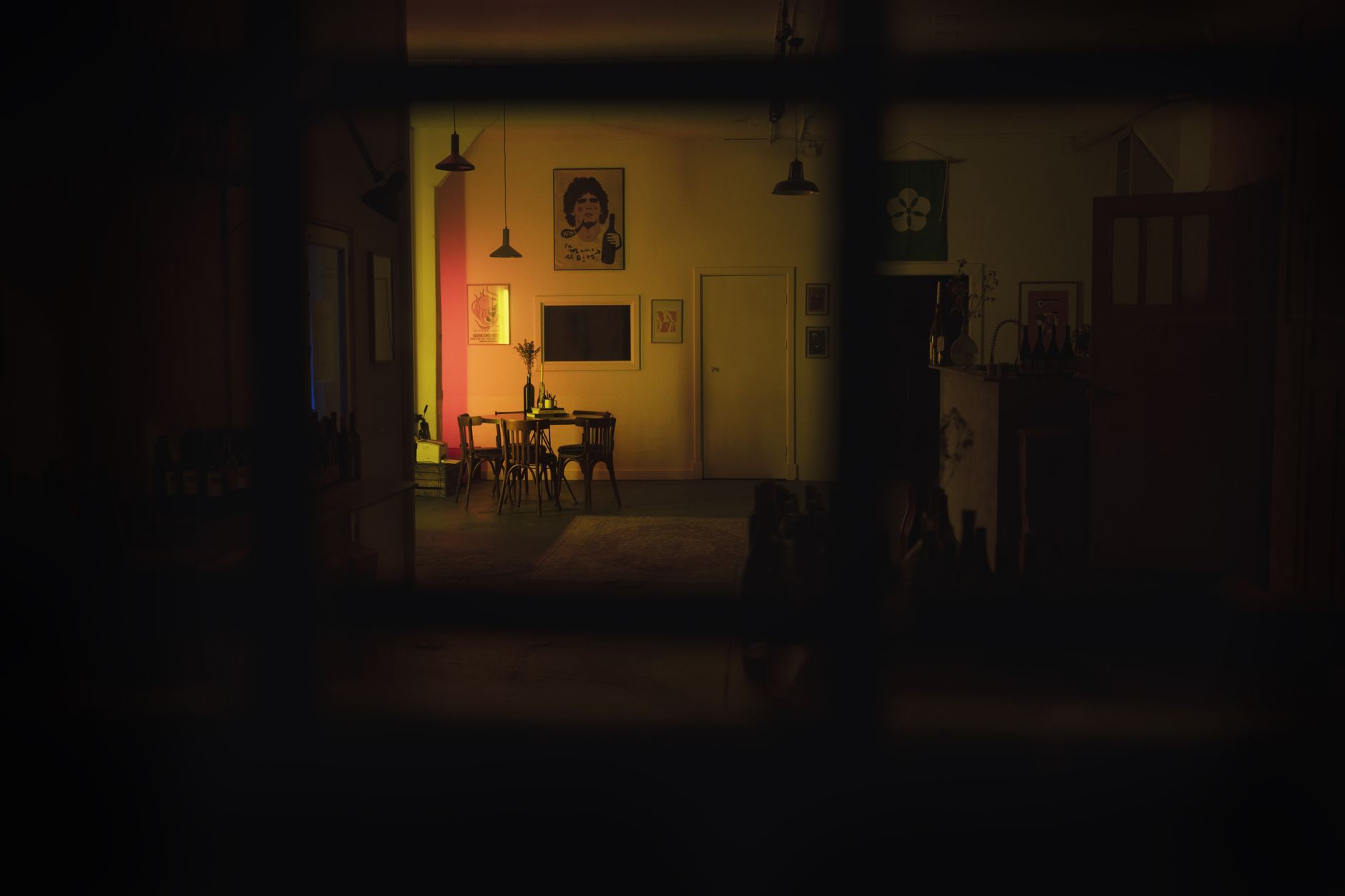 A dark room with a lit doorway beyond
