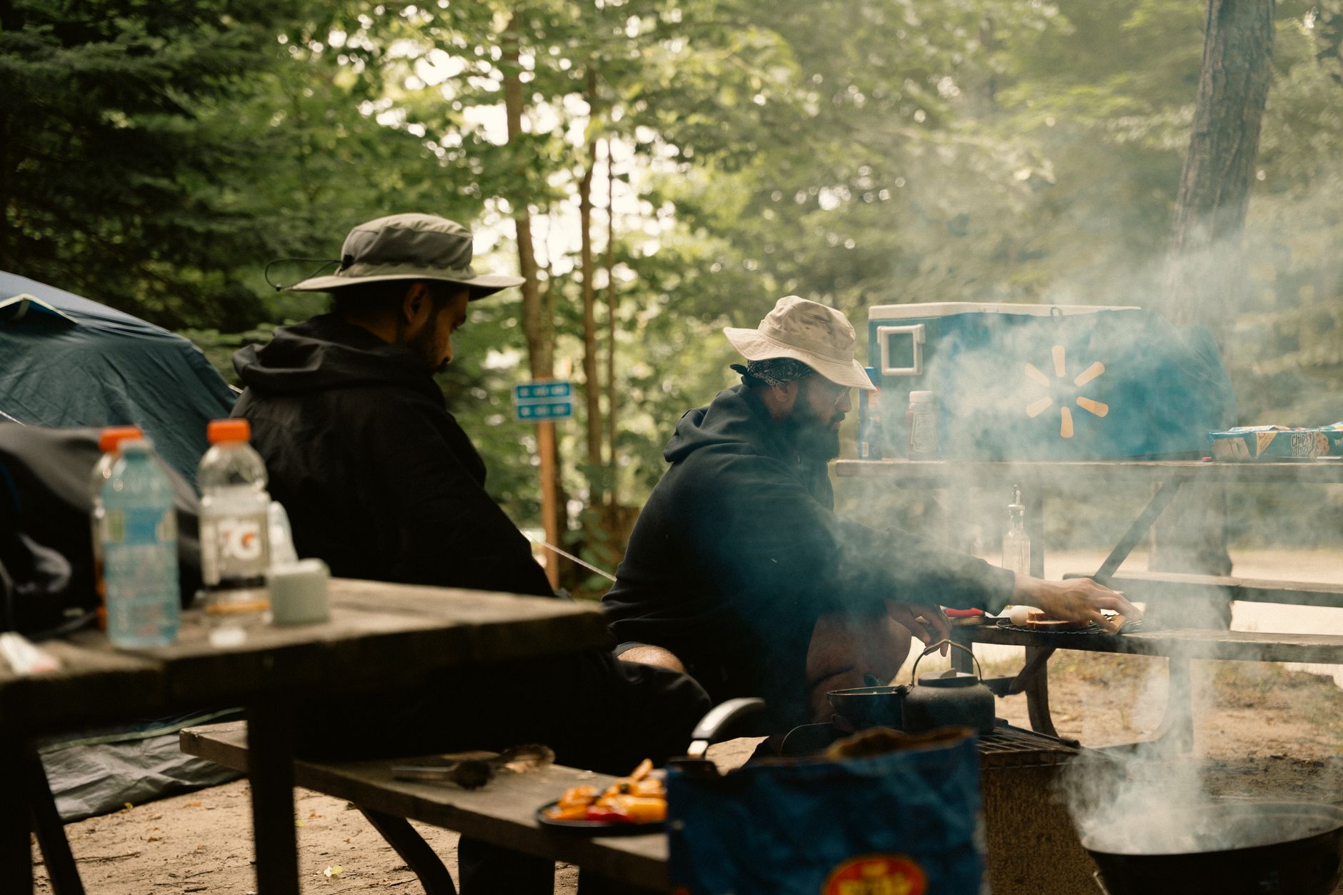 Campers cooking at a picnic table