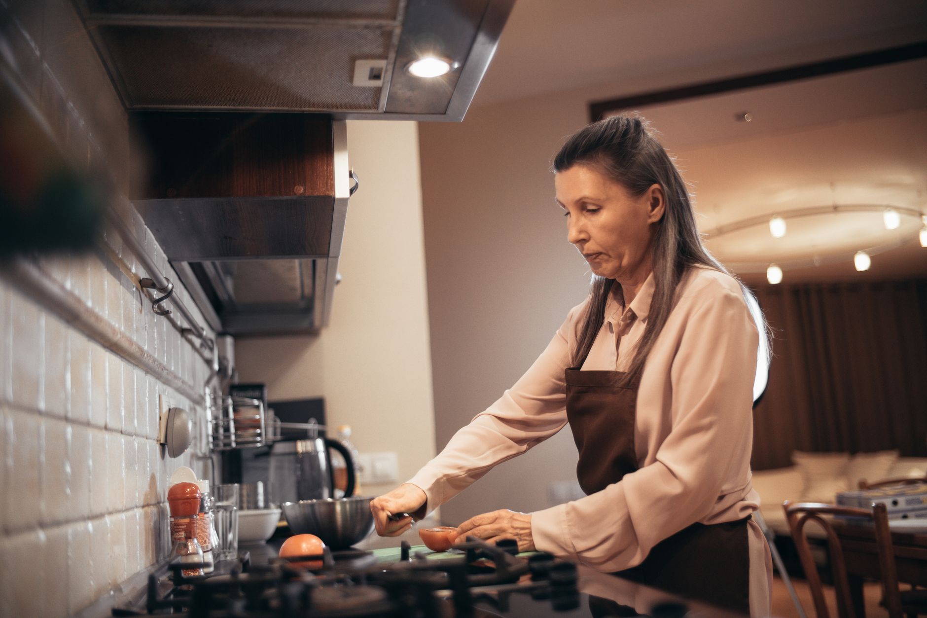 A woman cooking at a stove