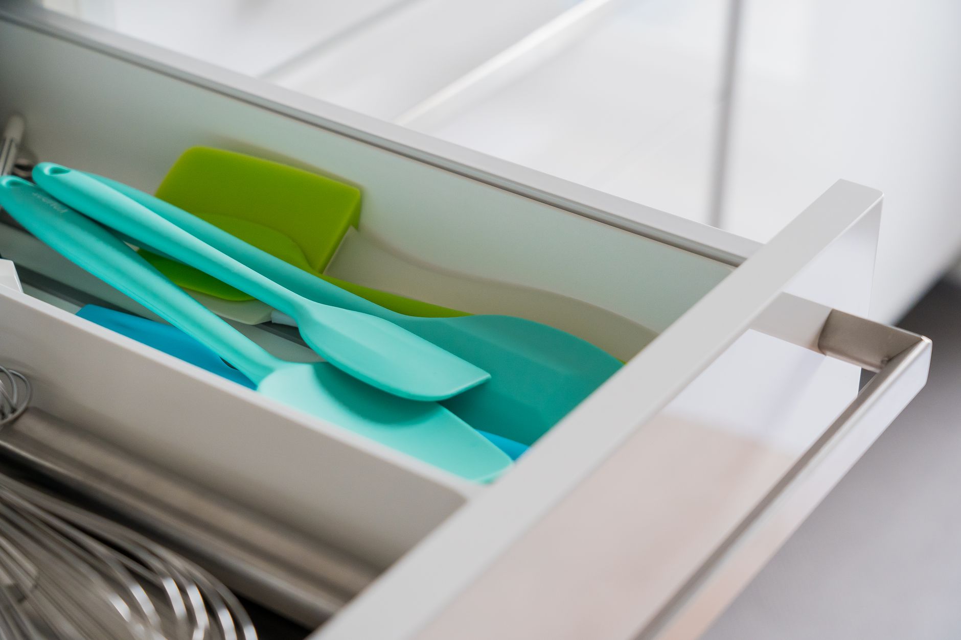 Colorful utensils in a kitchen drawer