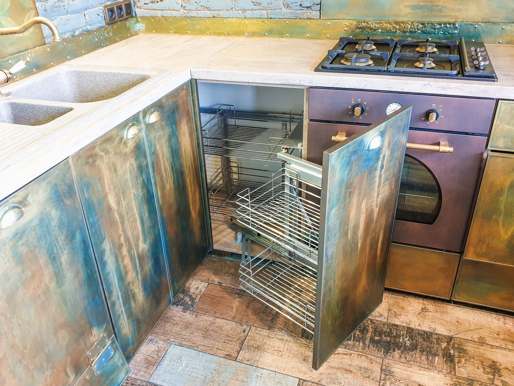 A pull-out corner rack inside a kitchen cabinet
