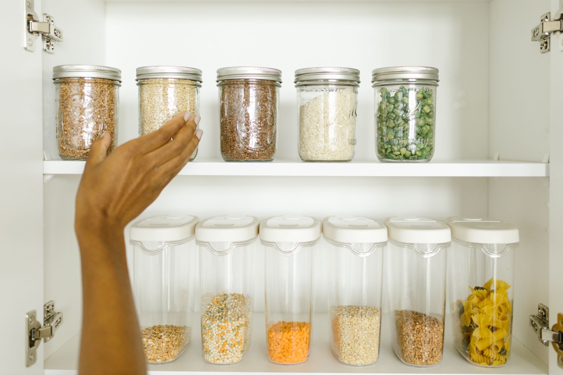 Jars of grains and pasta on cabinet shelves