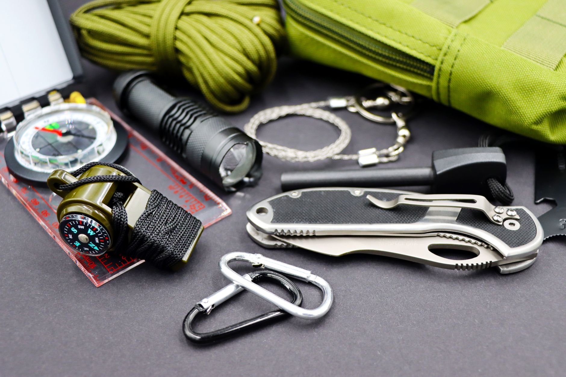 Emergency gear including a flashlight, compass and multi-tool