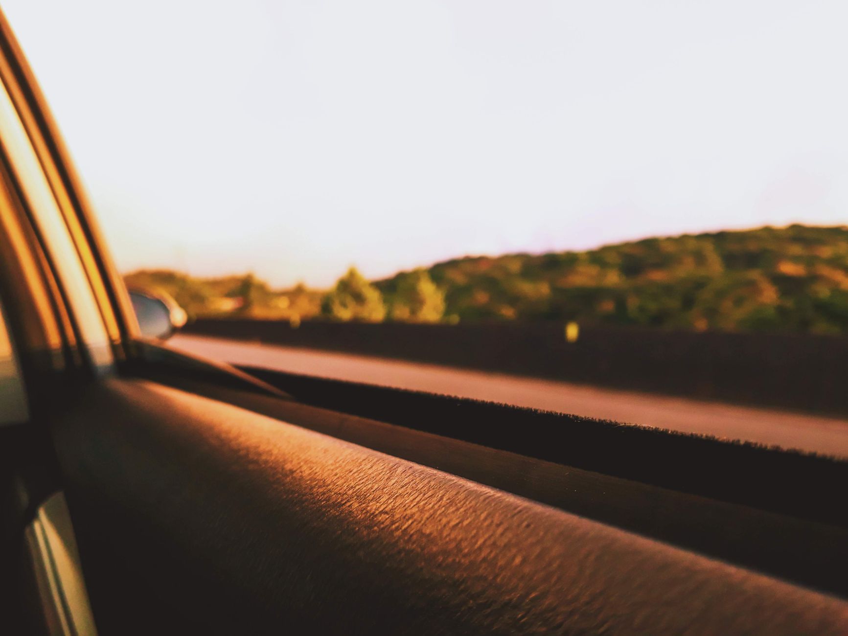A car window rolled down while driving