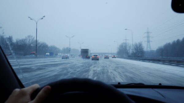 Best car emergency kit: a car driving on a snowy winter road