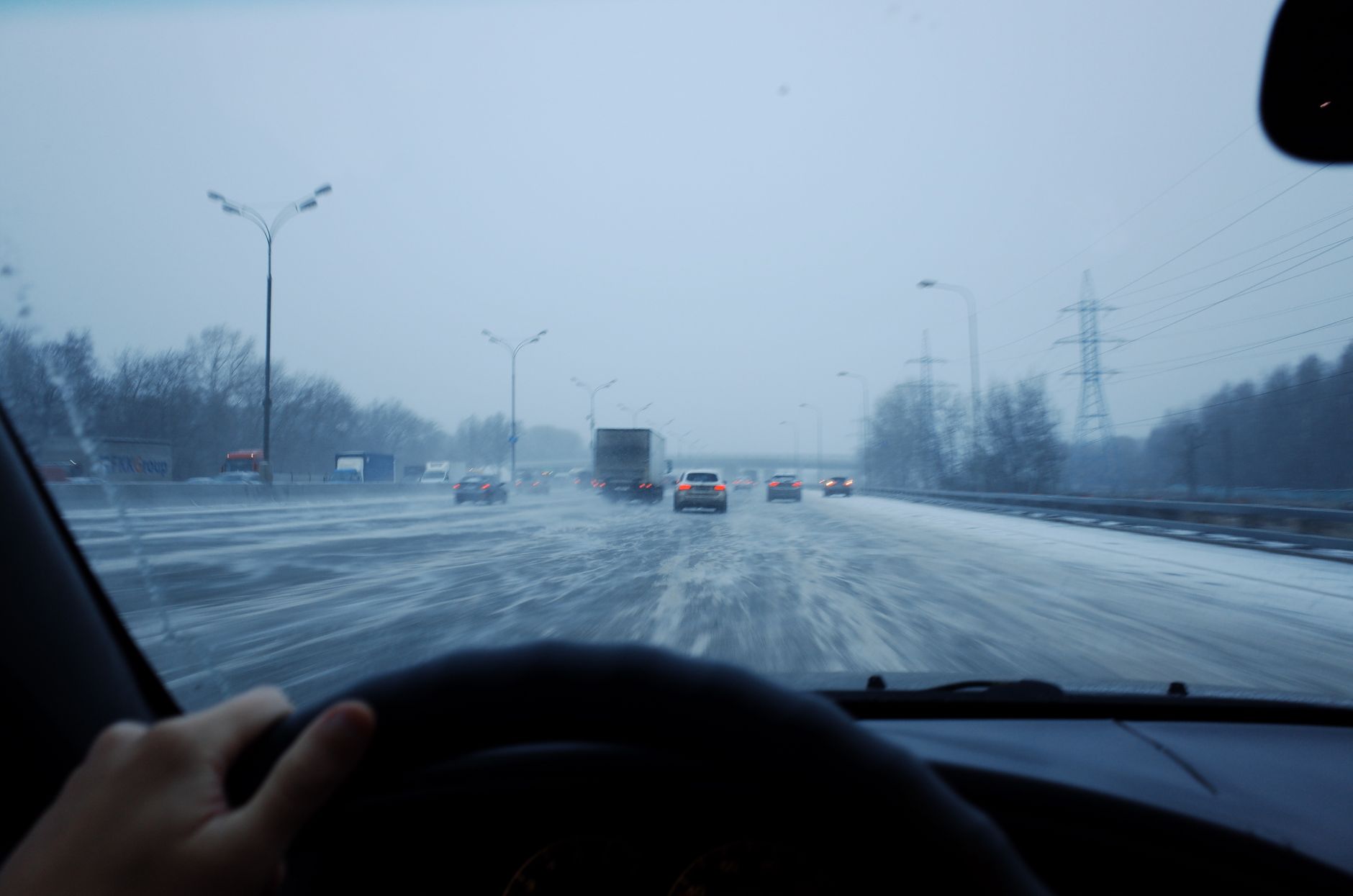 Best car emergency kit: a car driving on a snowy winter road