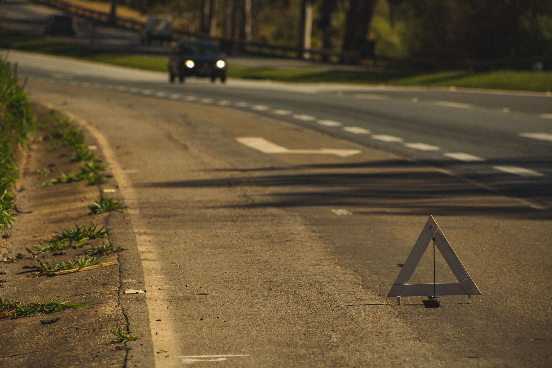 A warning triangle set out at the side of the road