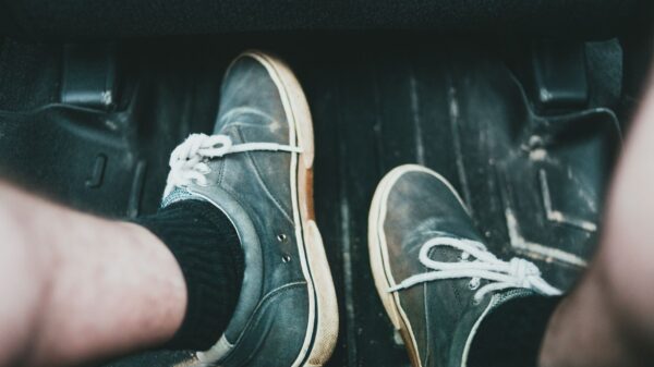 Best all weather car floor mats: sneakers on the floor mat by the pedals