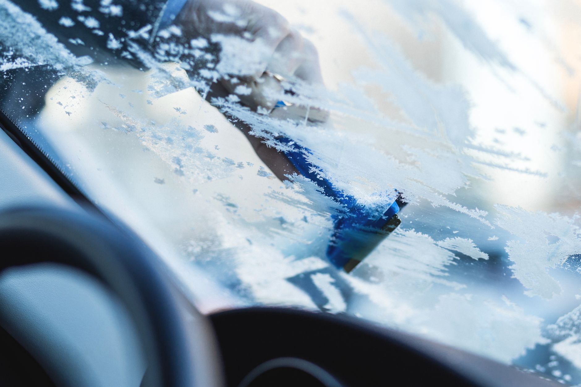 Scraping frost off a car windshield