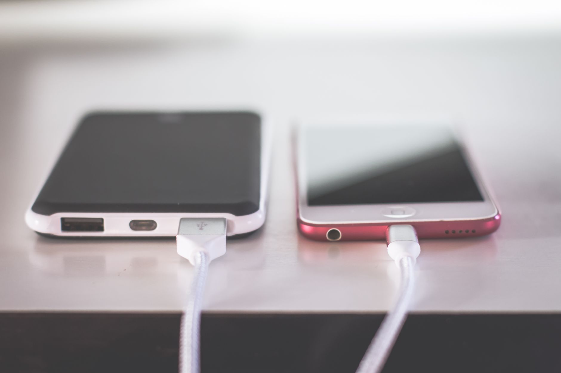 Two phones charging on a table