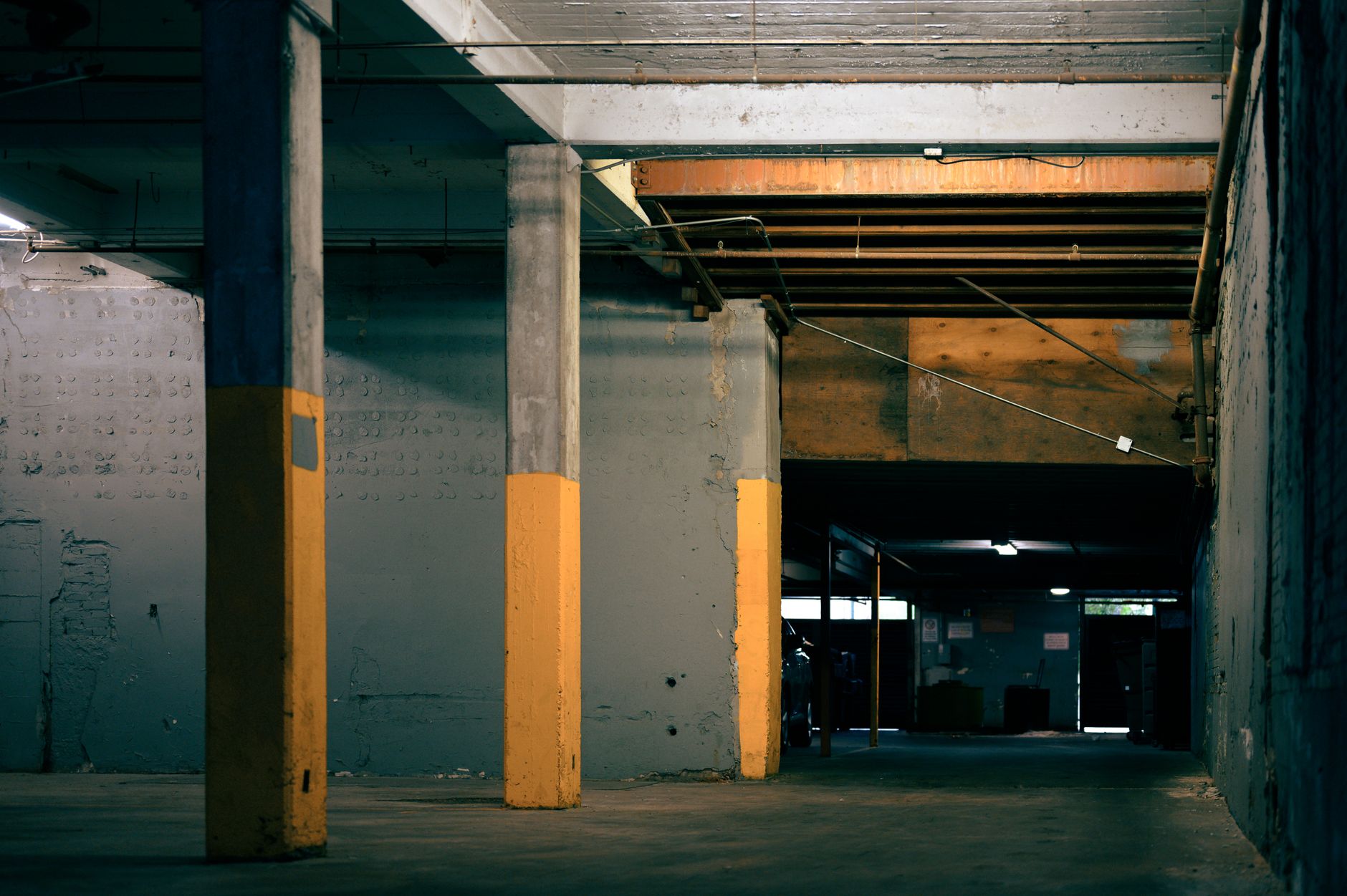 An empty parking garage with concrete pillars