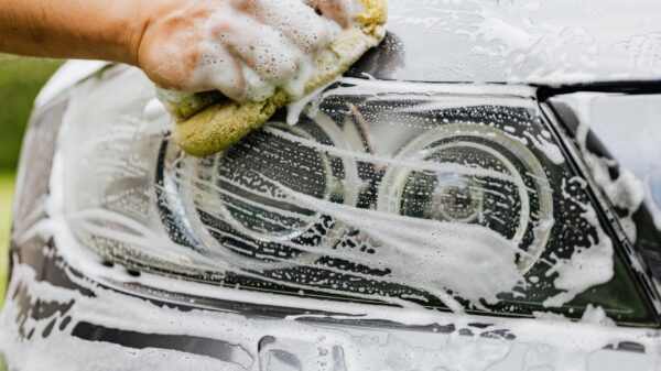 Best car wash kit: washing a car by hand with a sponge and soapy water