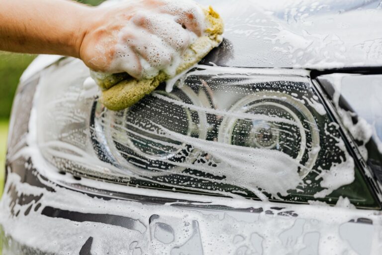 Best car wash kit: washing a car by hand with a sponge and soapy water