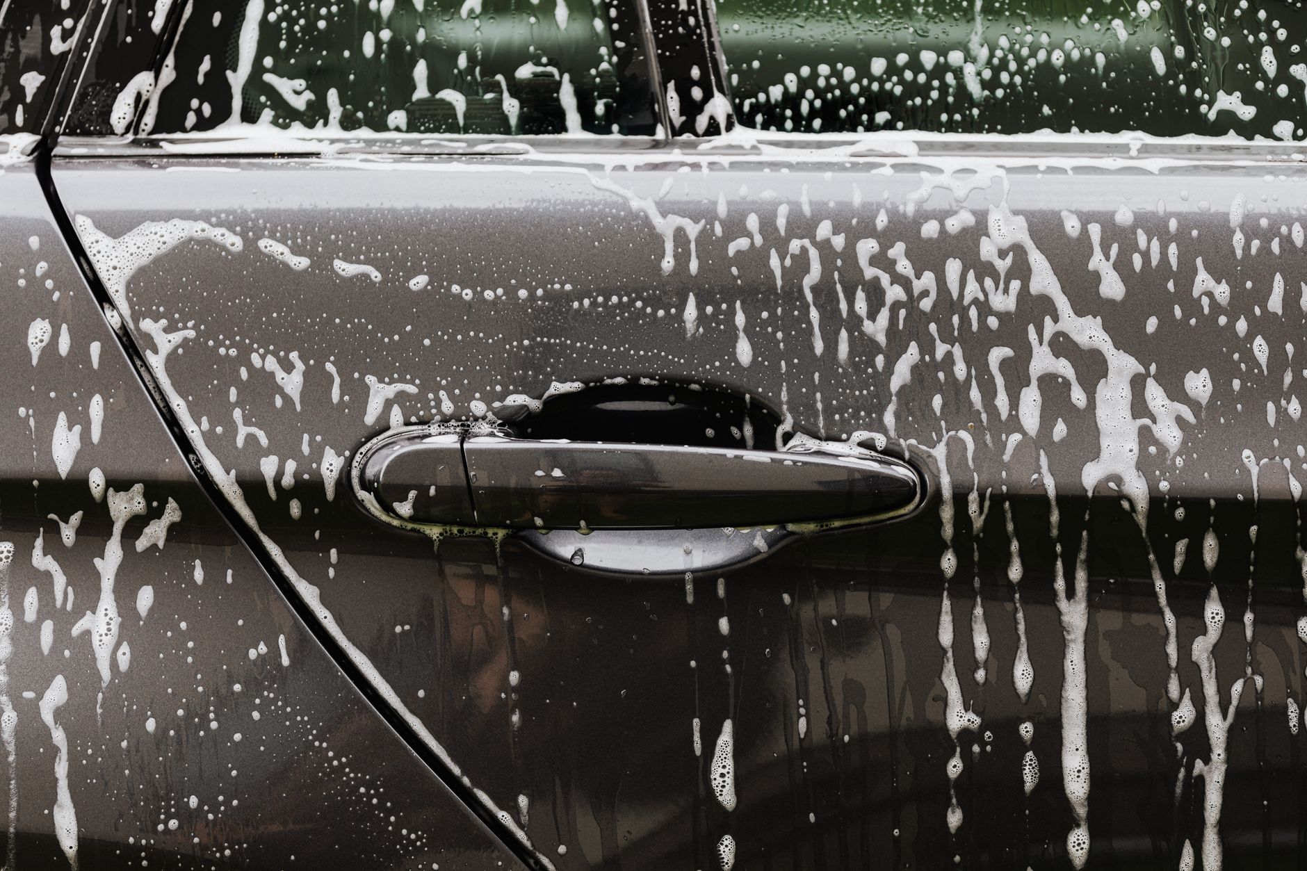 Soapy foam covering the side of a car
