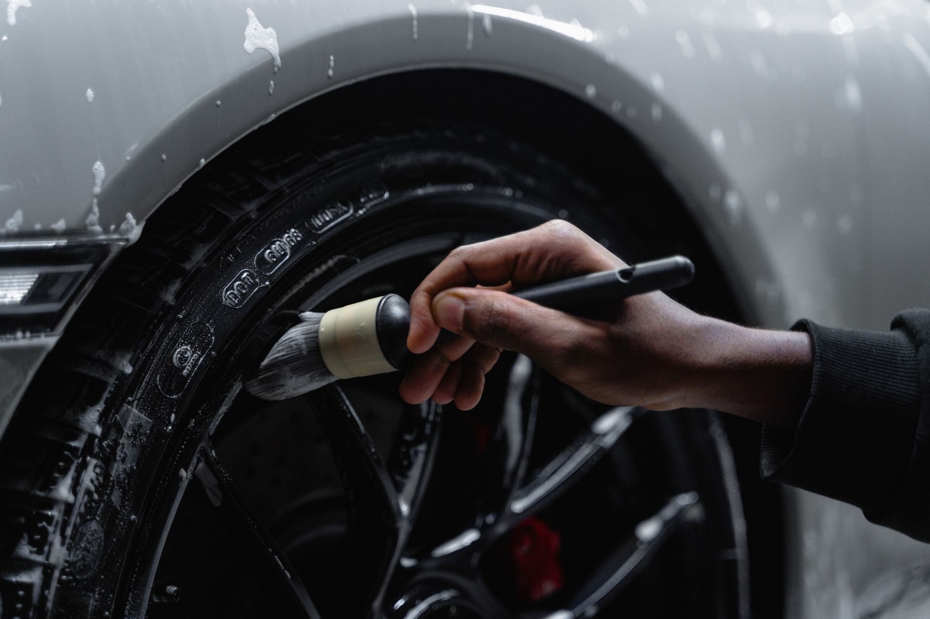 Cleaning a car wheel with a brush
