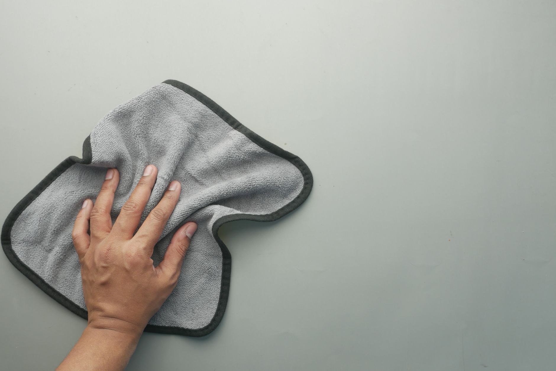 Drying a freshly washed car with a towel