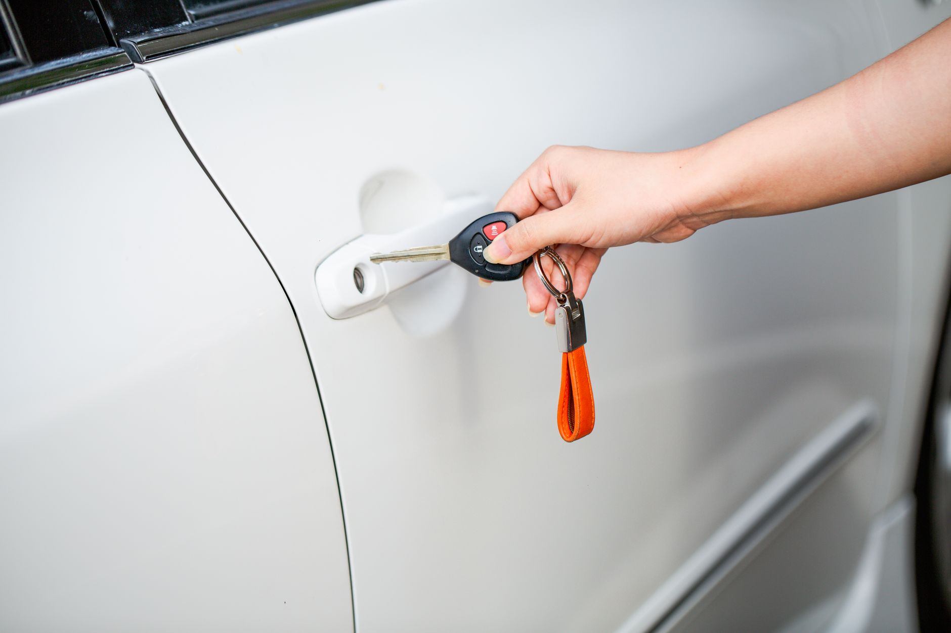 A key unlocking a car door