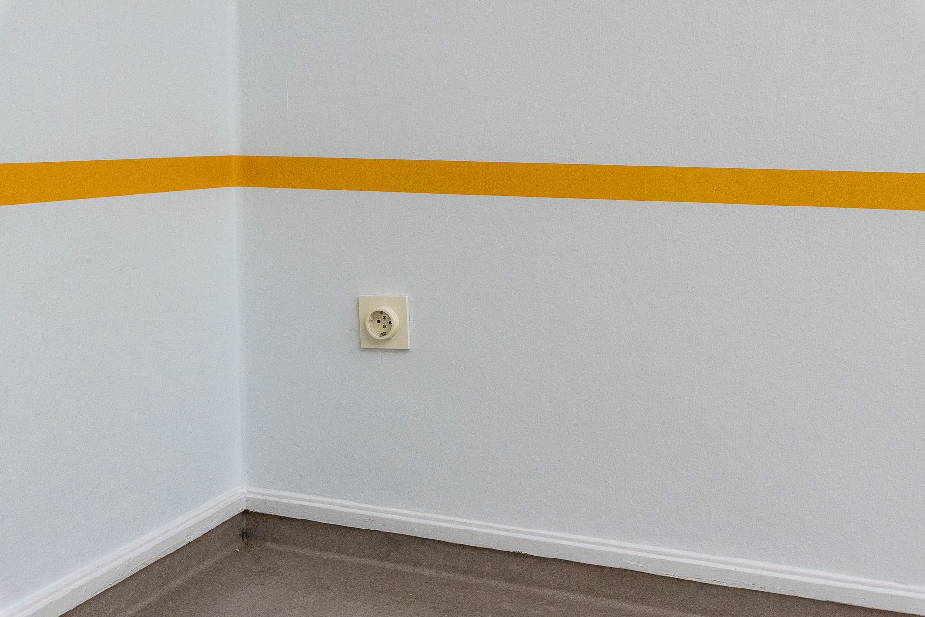 A wall outlet in an empty room