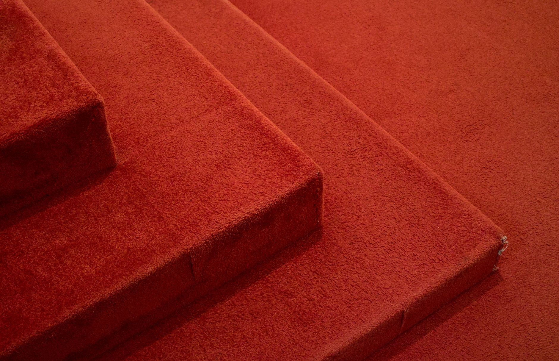 Close-up of red carpeted stairs