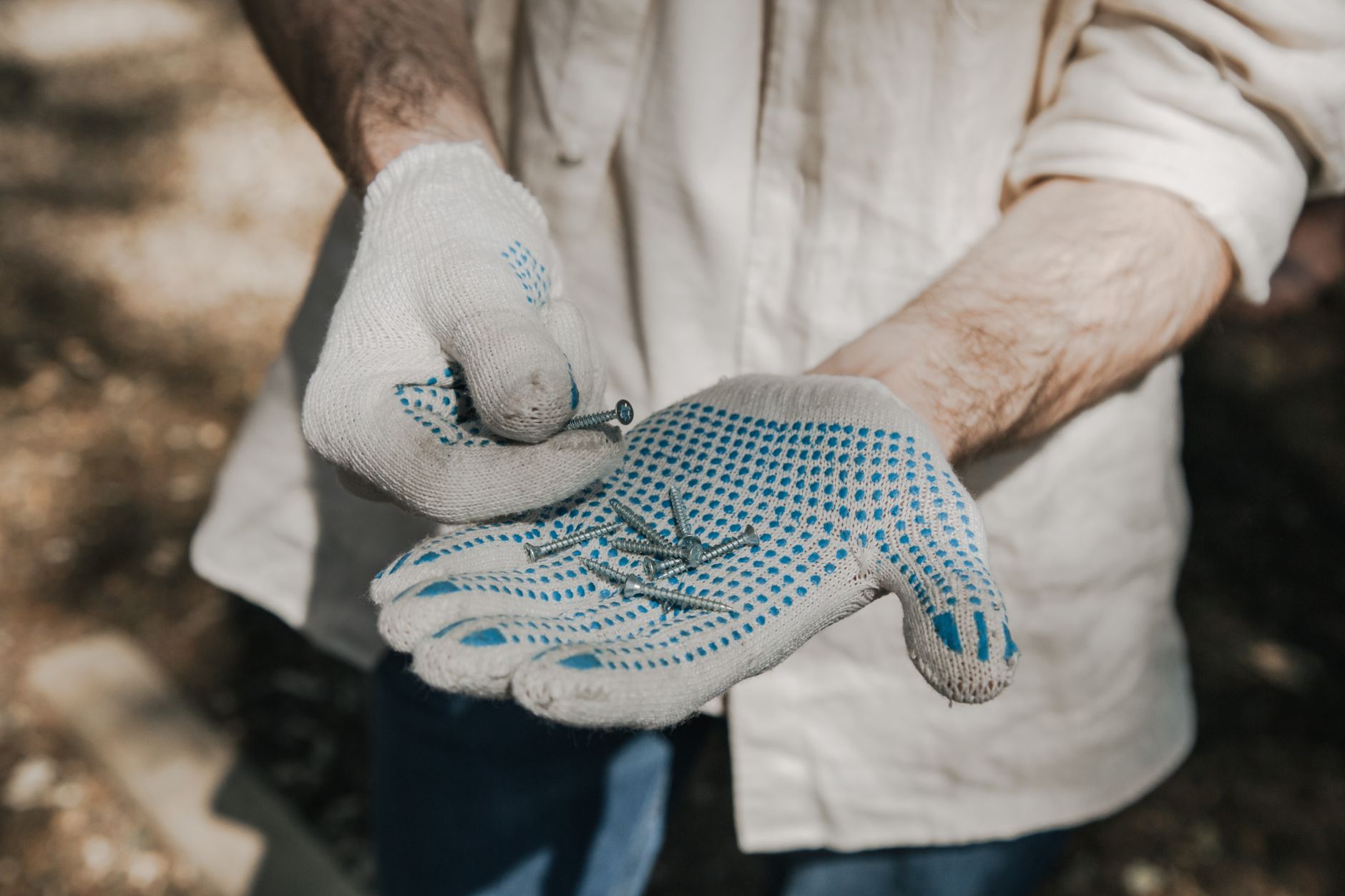 A person putting on work gloves