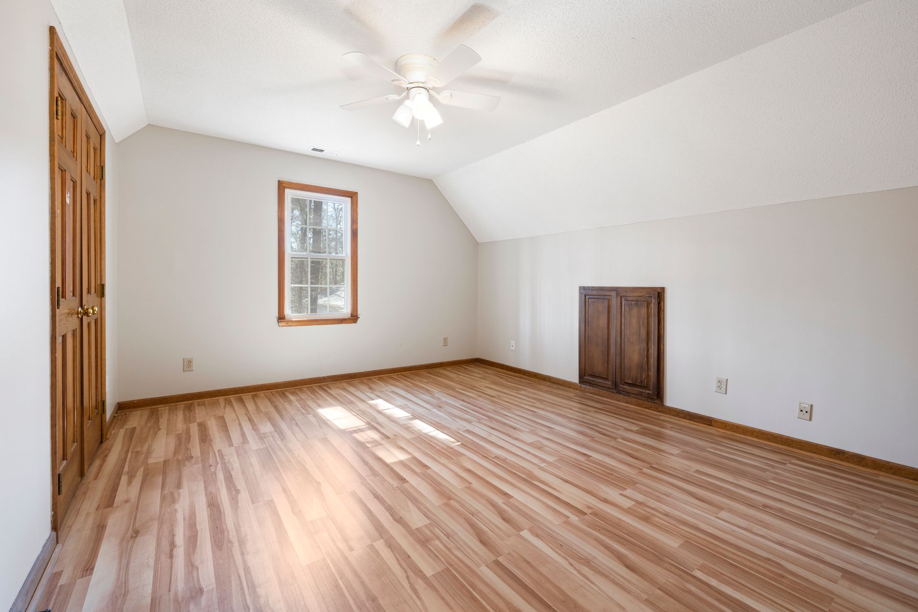 An empty room with a hardwood floor