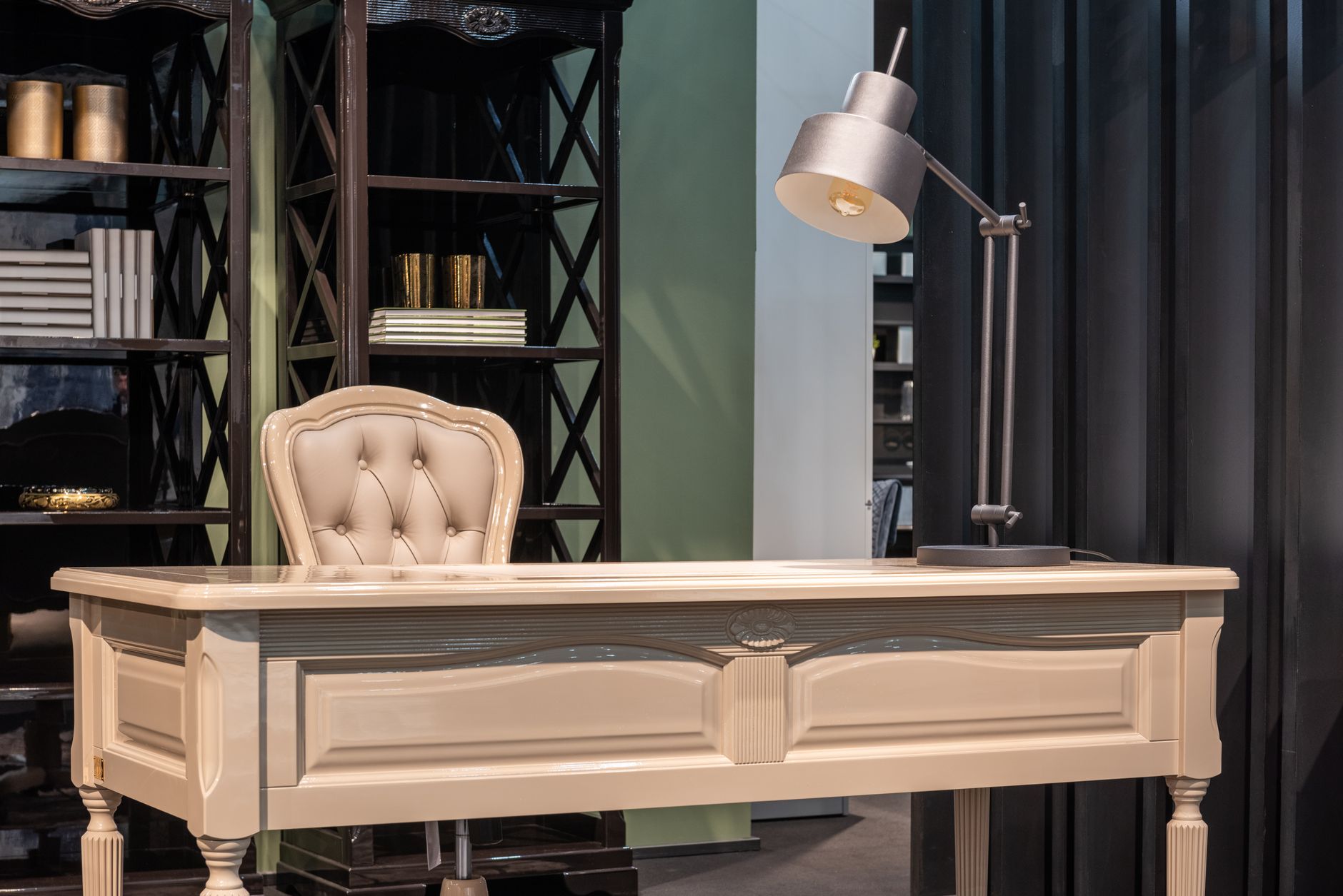 A cream desk with a lamp in a study