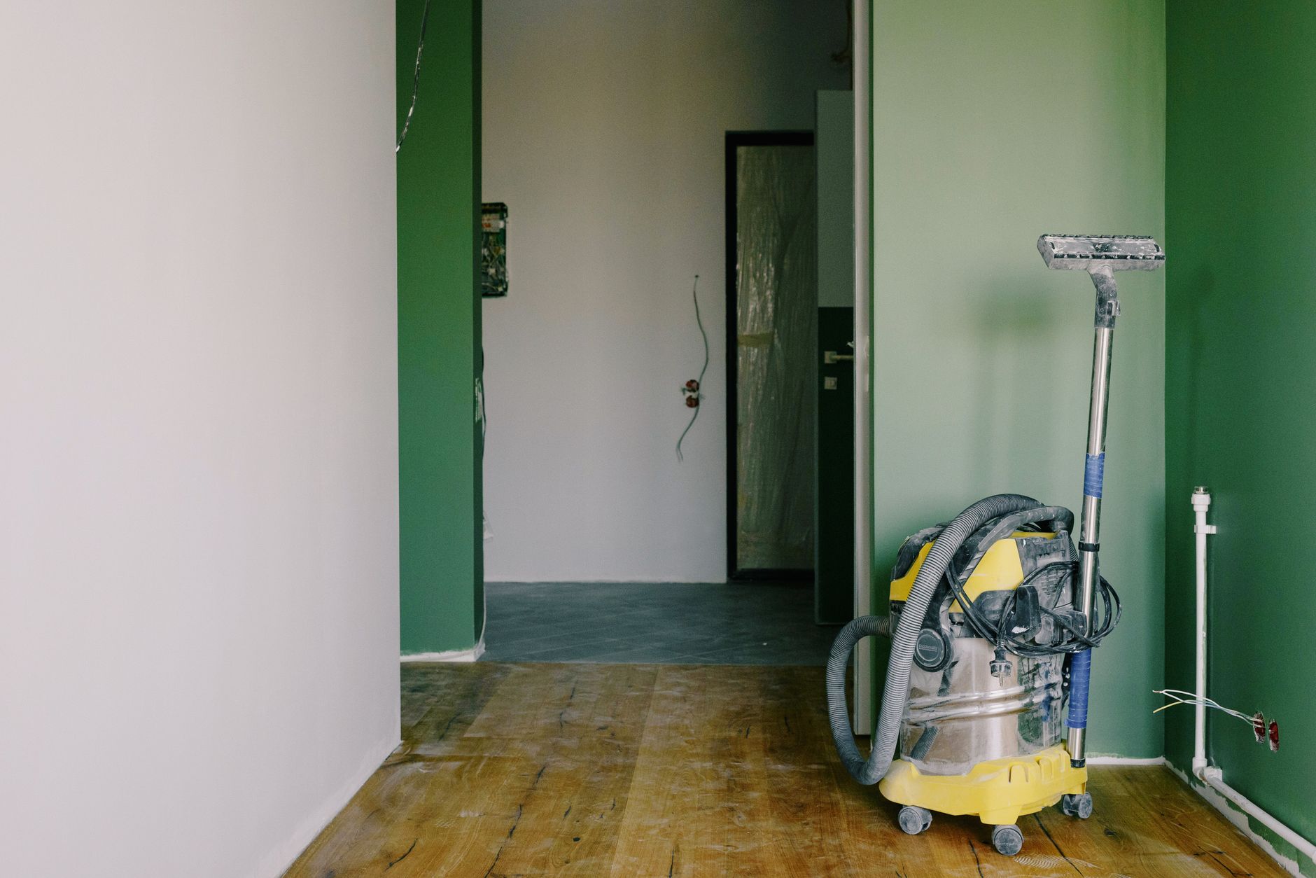 A wet-dry vacuum in a room under renovation