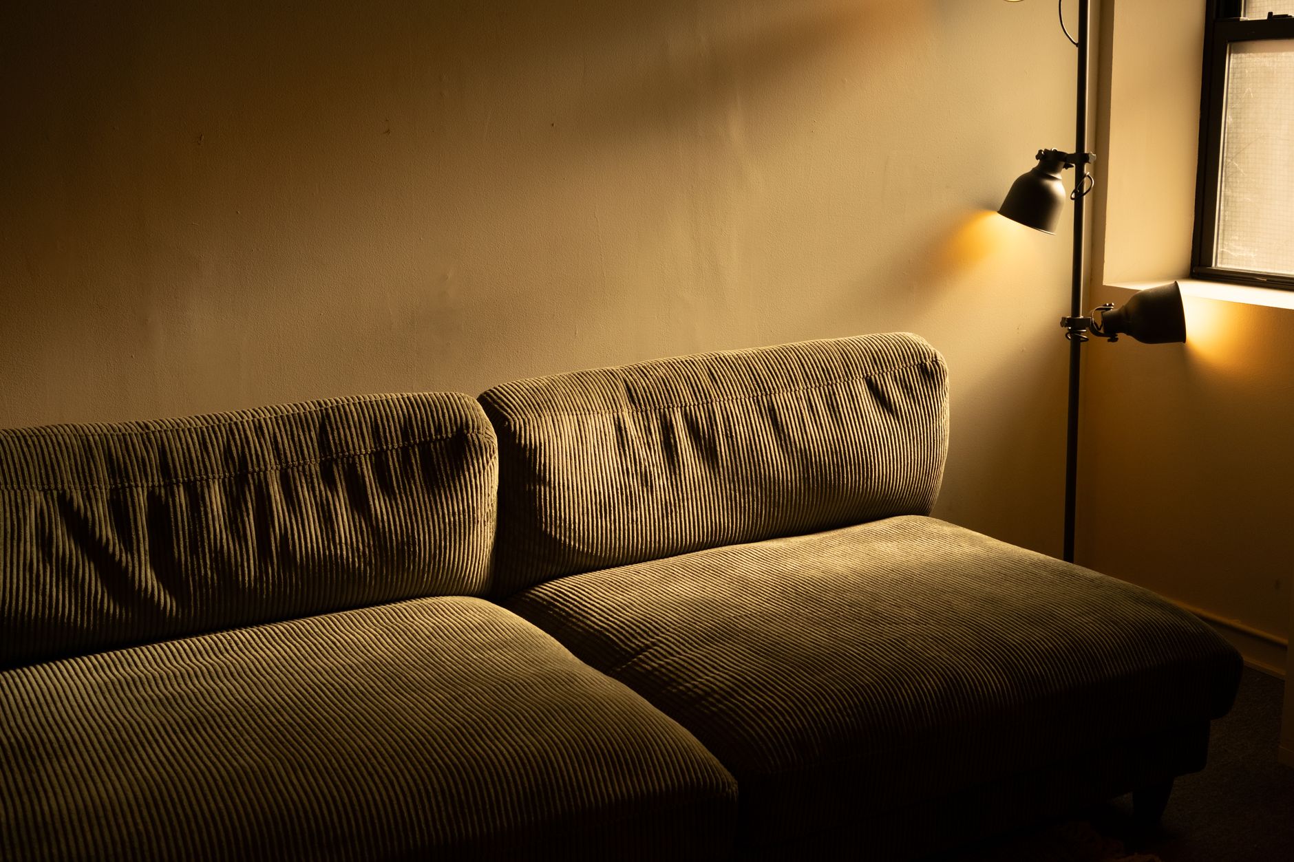 A living room lit by a lamp