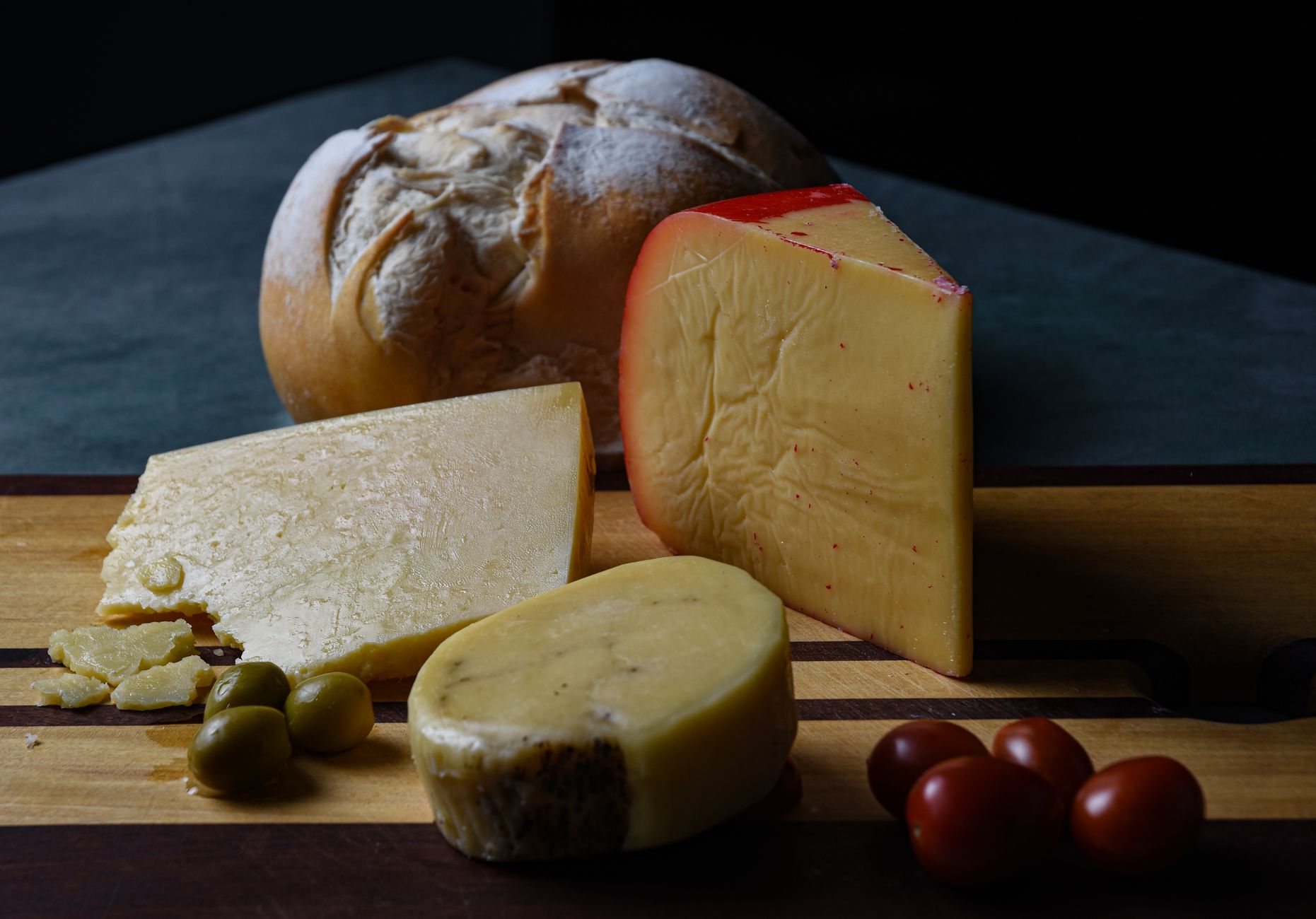 A block of hard cheese on a board