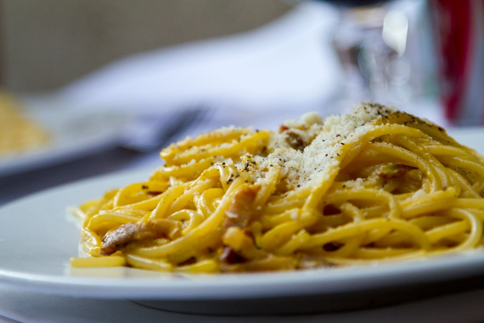 A plate of pasta topped with grated cheese