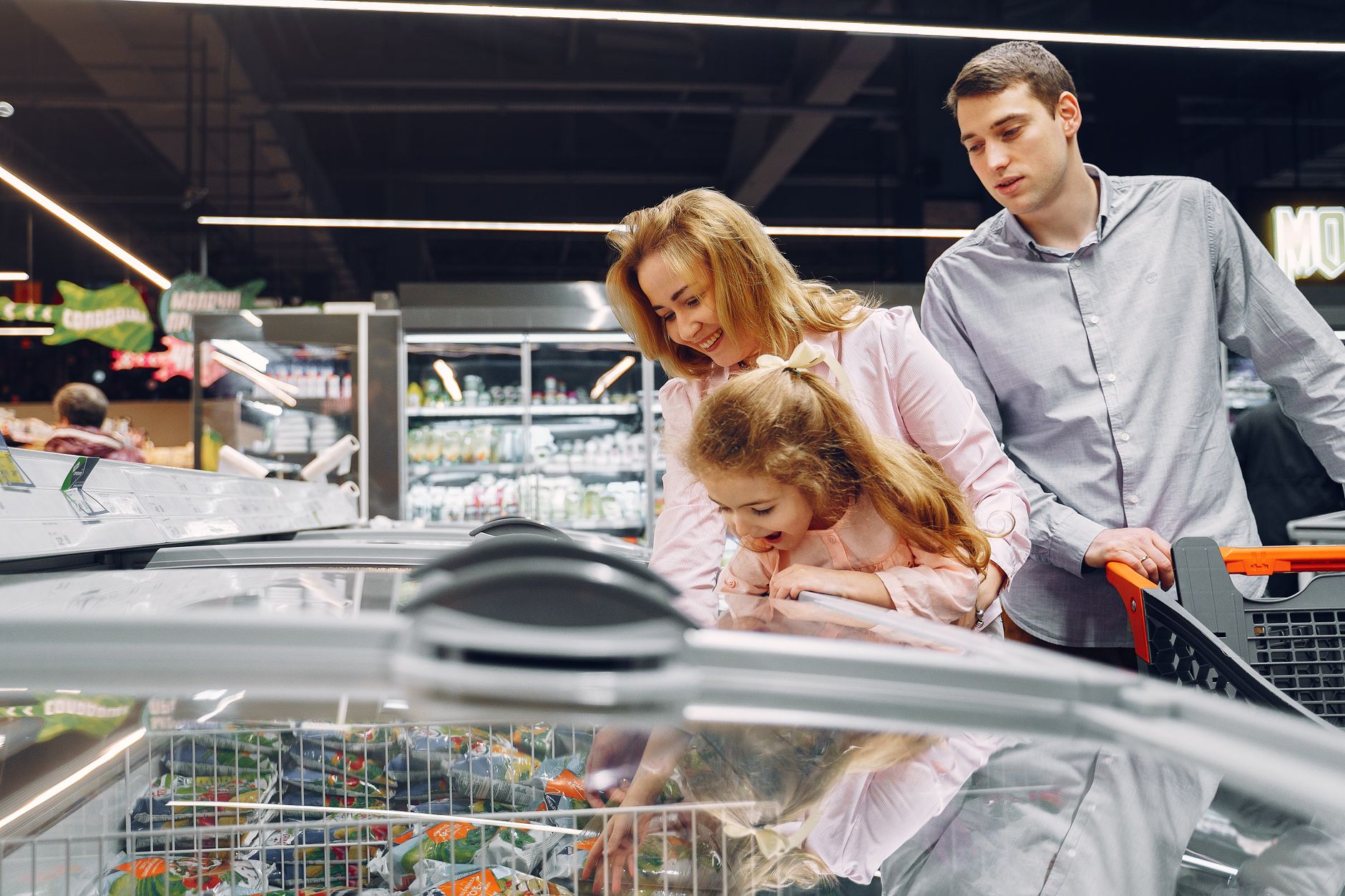 Best chest freezer: a family looking into a supermarket chest freezer