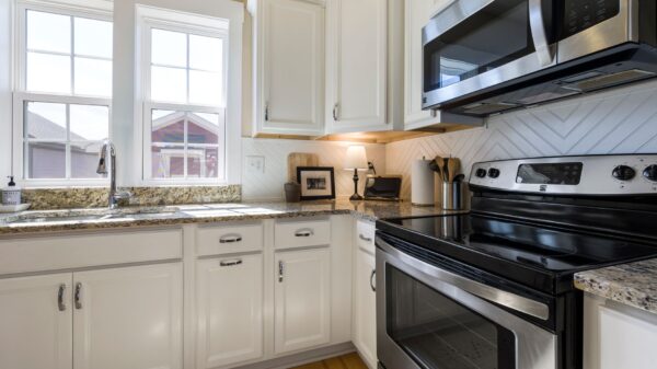 A kitchen with white cabinets and stainless appliances