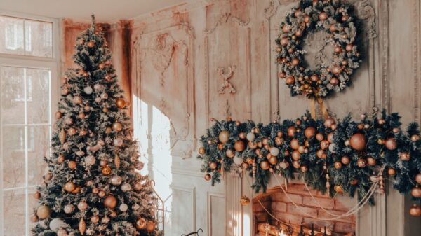 Best christmas tree stand: a decorated tree beside a fireplace and garland