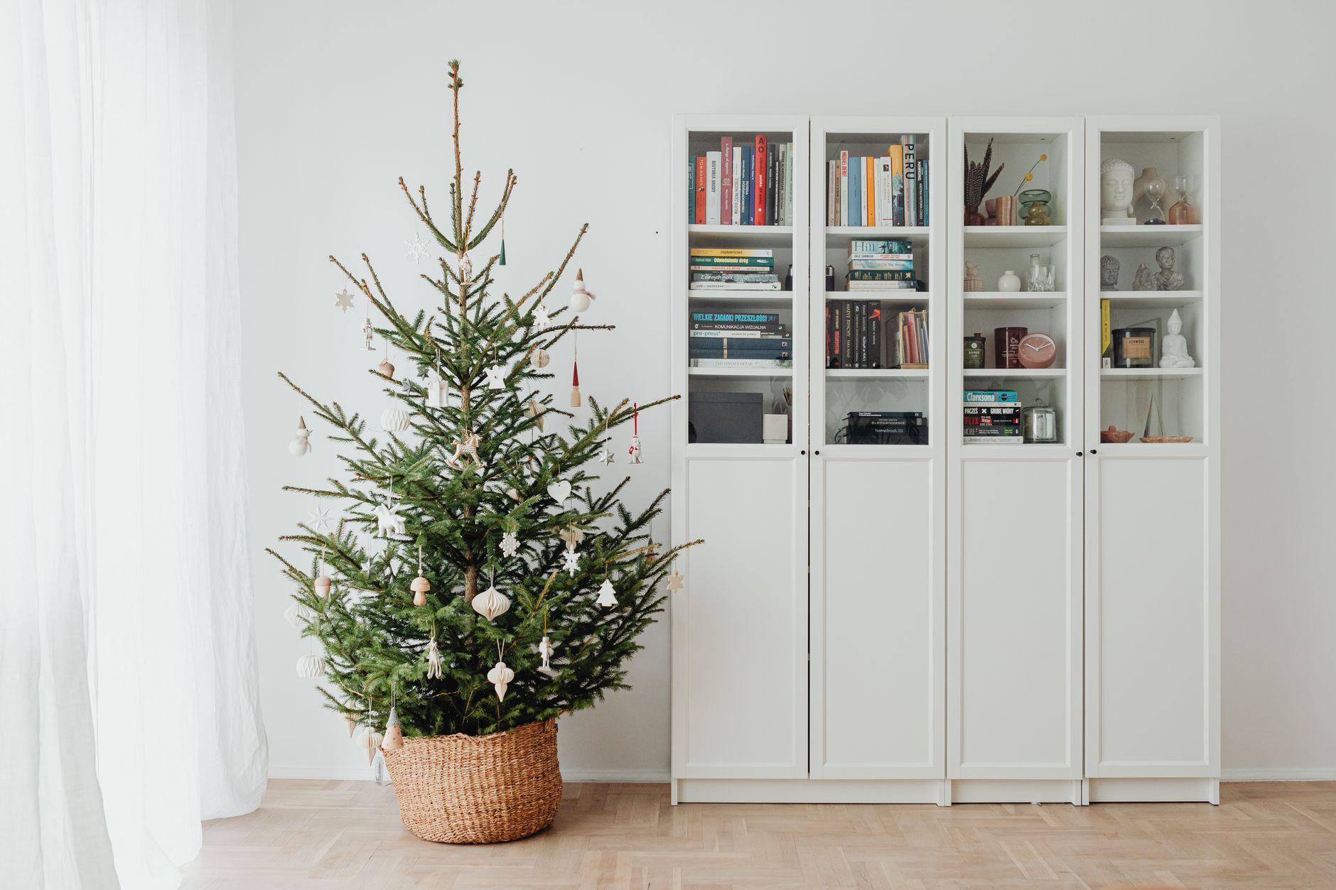 A simply decorated tree in a basket stand