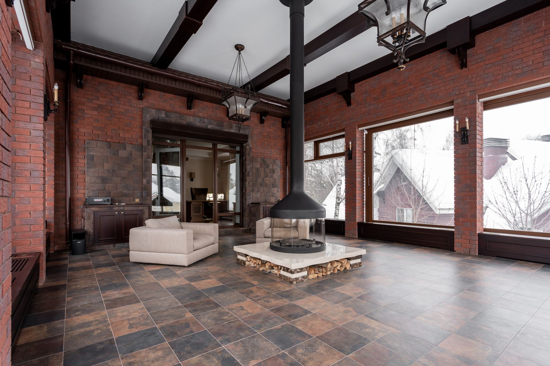 A brick room with a hanging fireplace