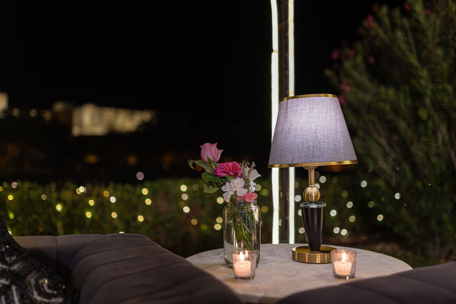 Best citronella candle: candles glowing on a patio table in the evening