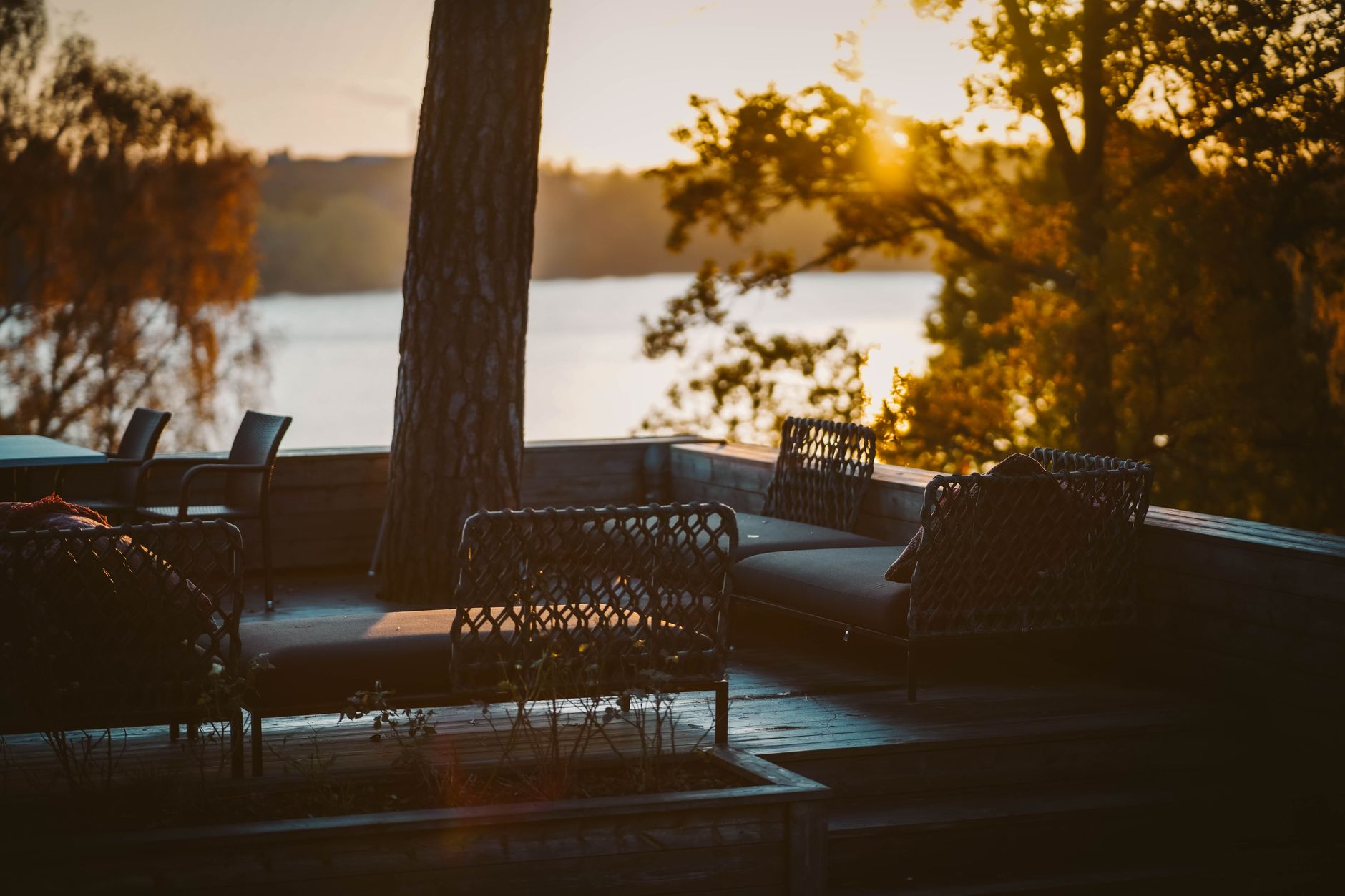 Outdoor furniture on a backyard deck at dusk