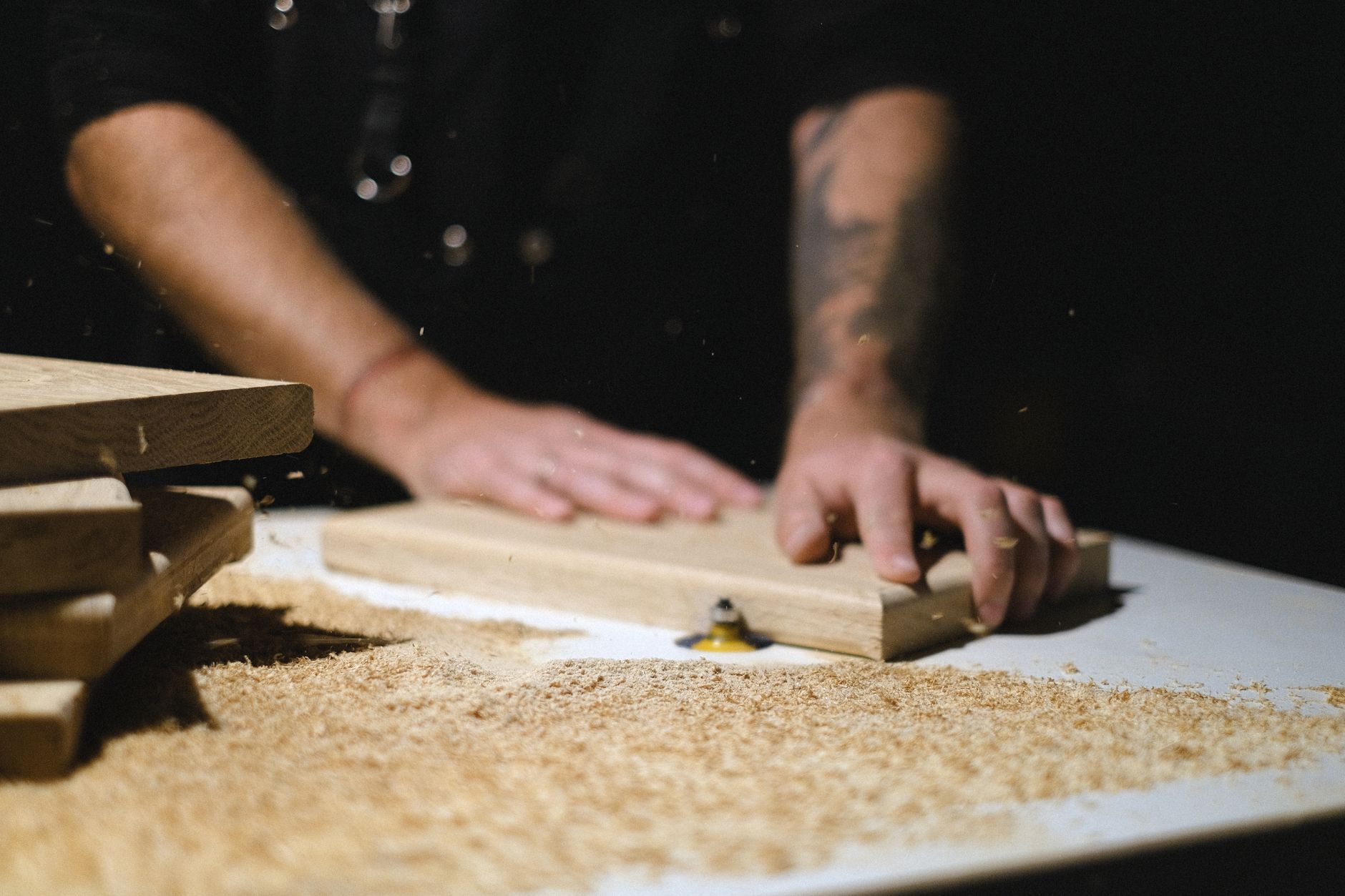A wooden plank being sanded on a bench