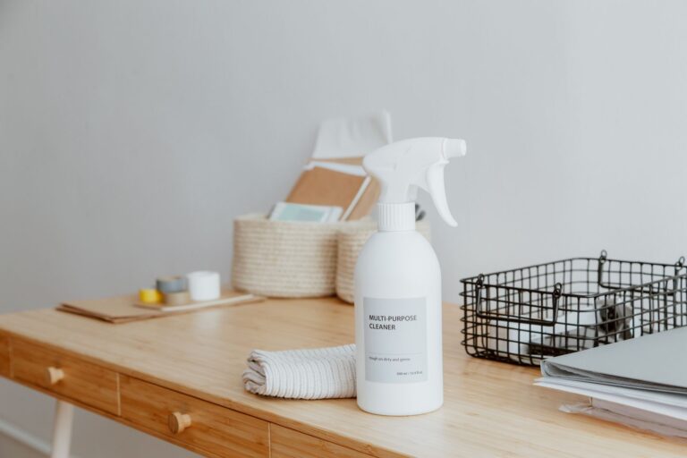 Best cleaning caddy: a spray bottle and baskets on a wooden desk