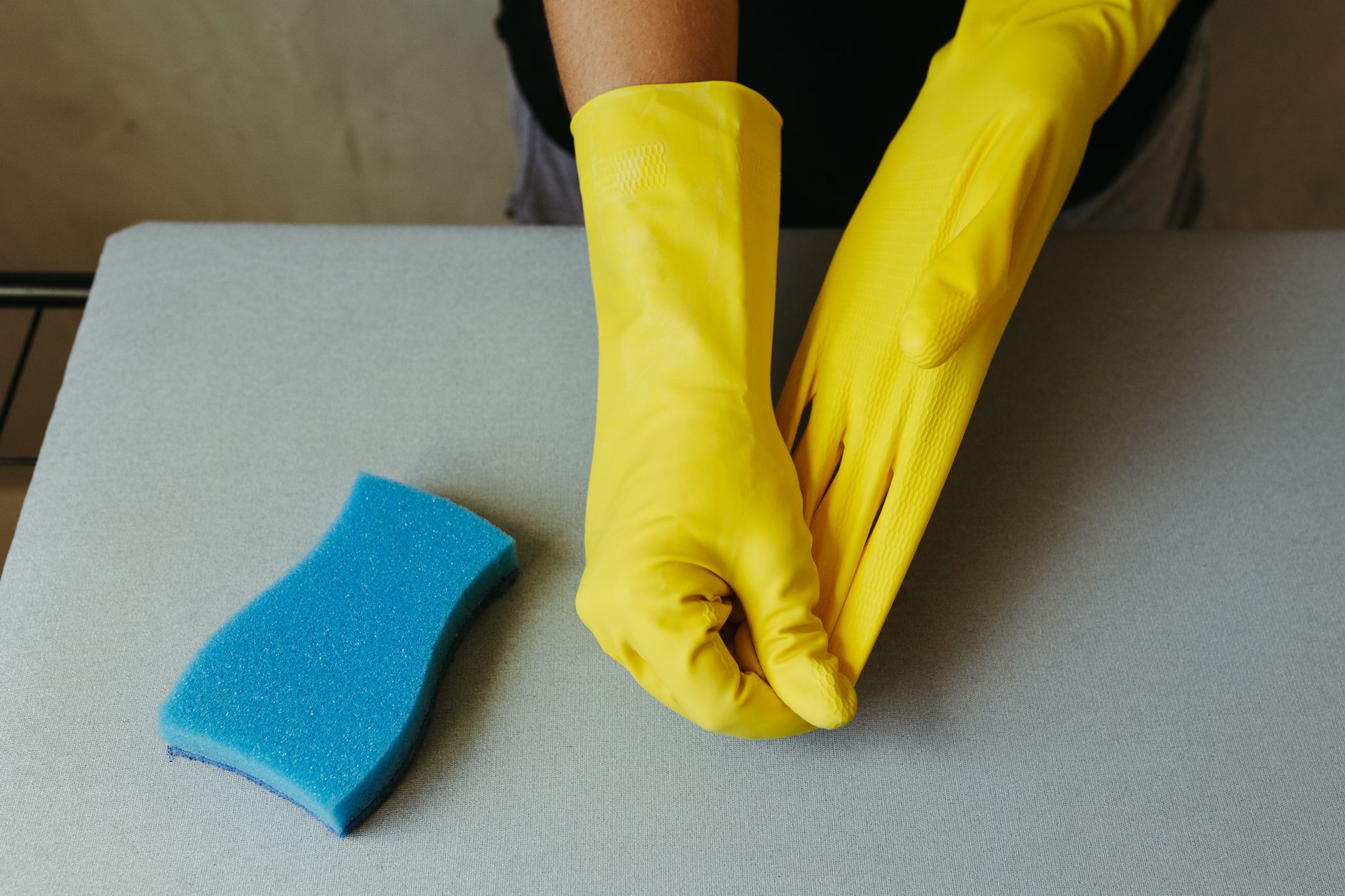 Best cleaning gloves: yellow rubber gloves and a sponge