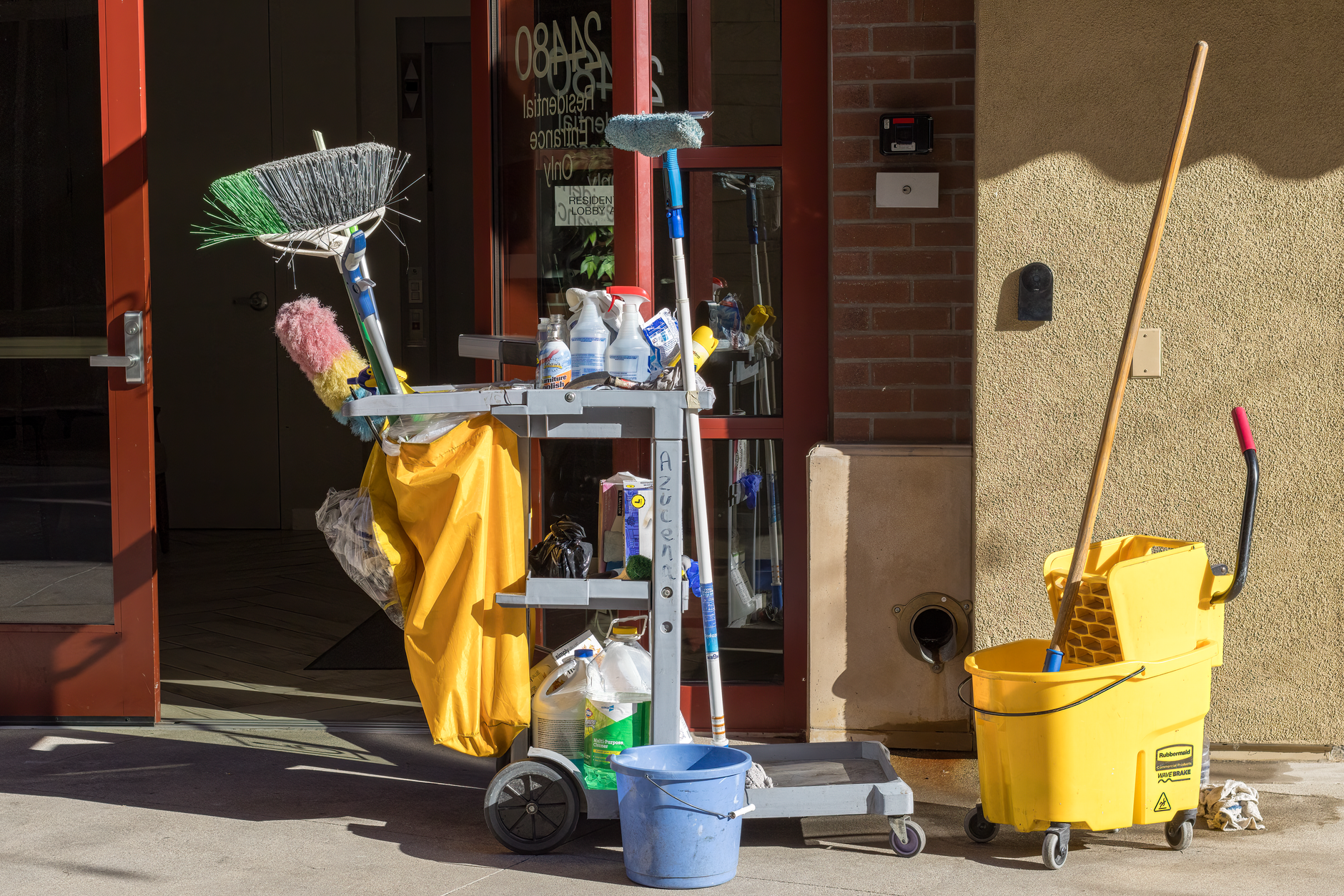 A cleaning cart with a mop bucket