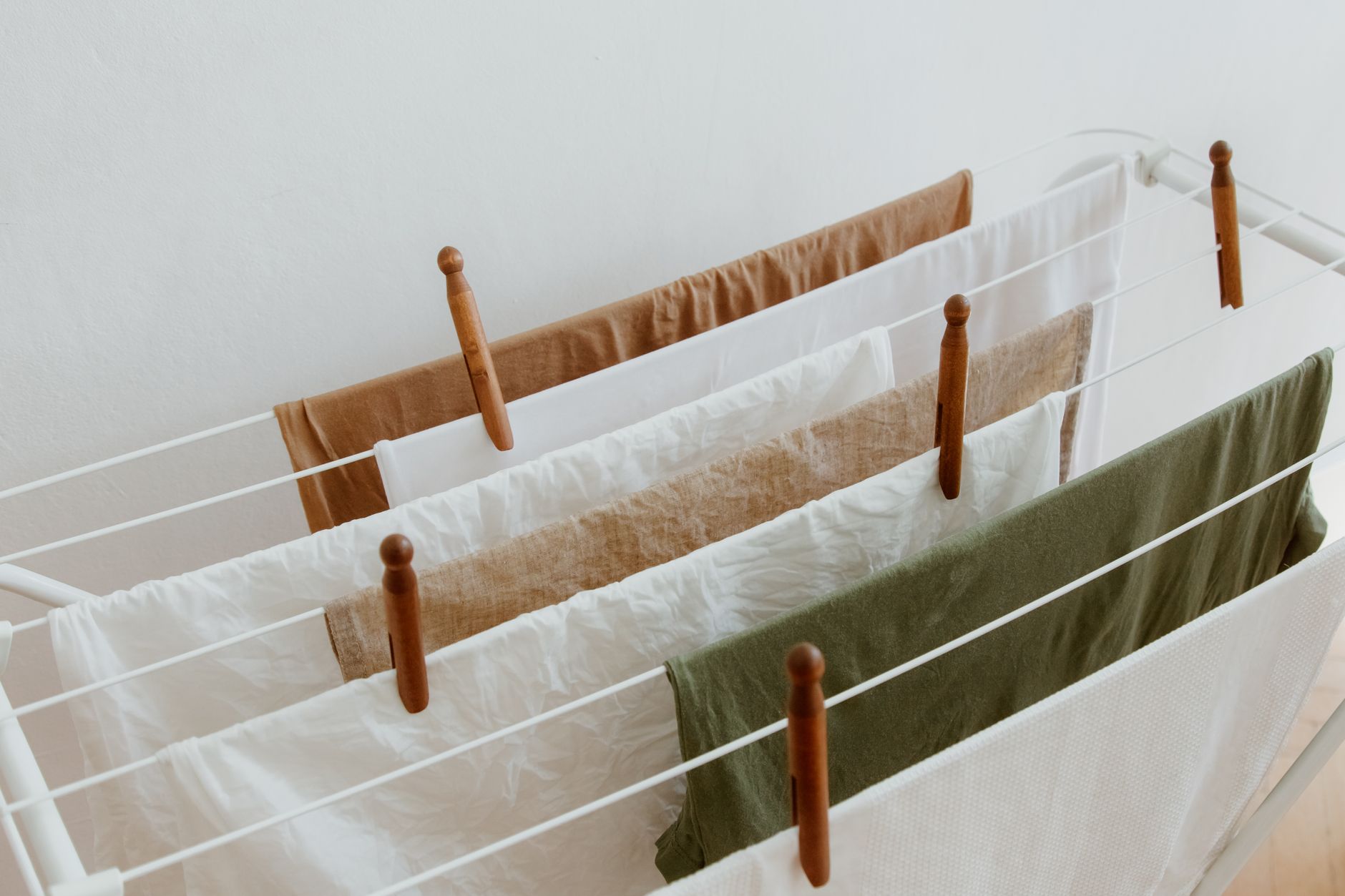 Clothes pinned on a white drying rack