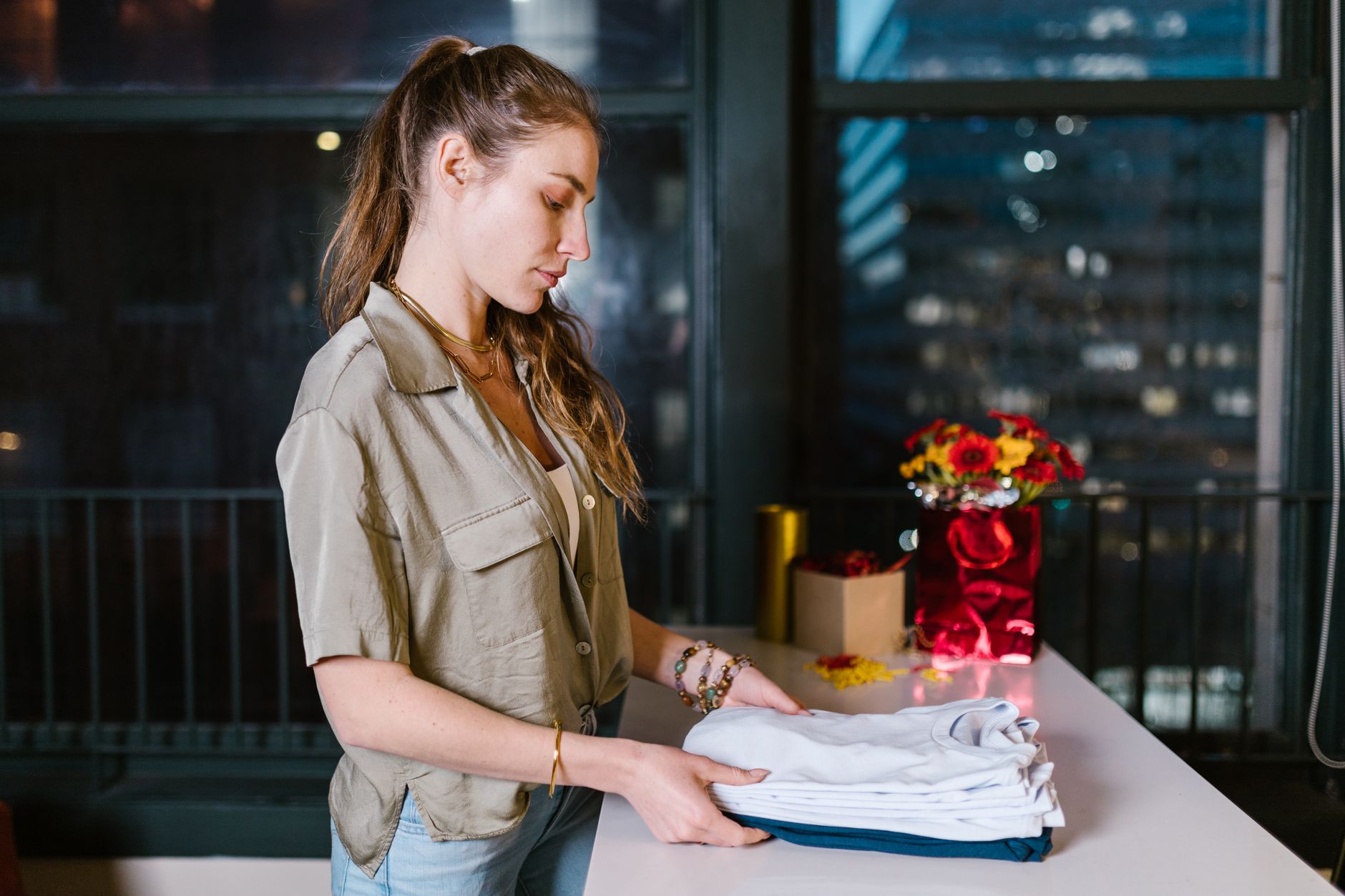 A woman folding clean laundry
