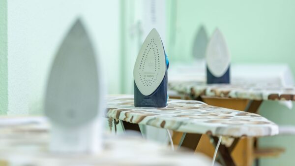 Irons standing on ironing boards