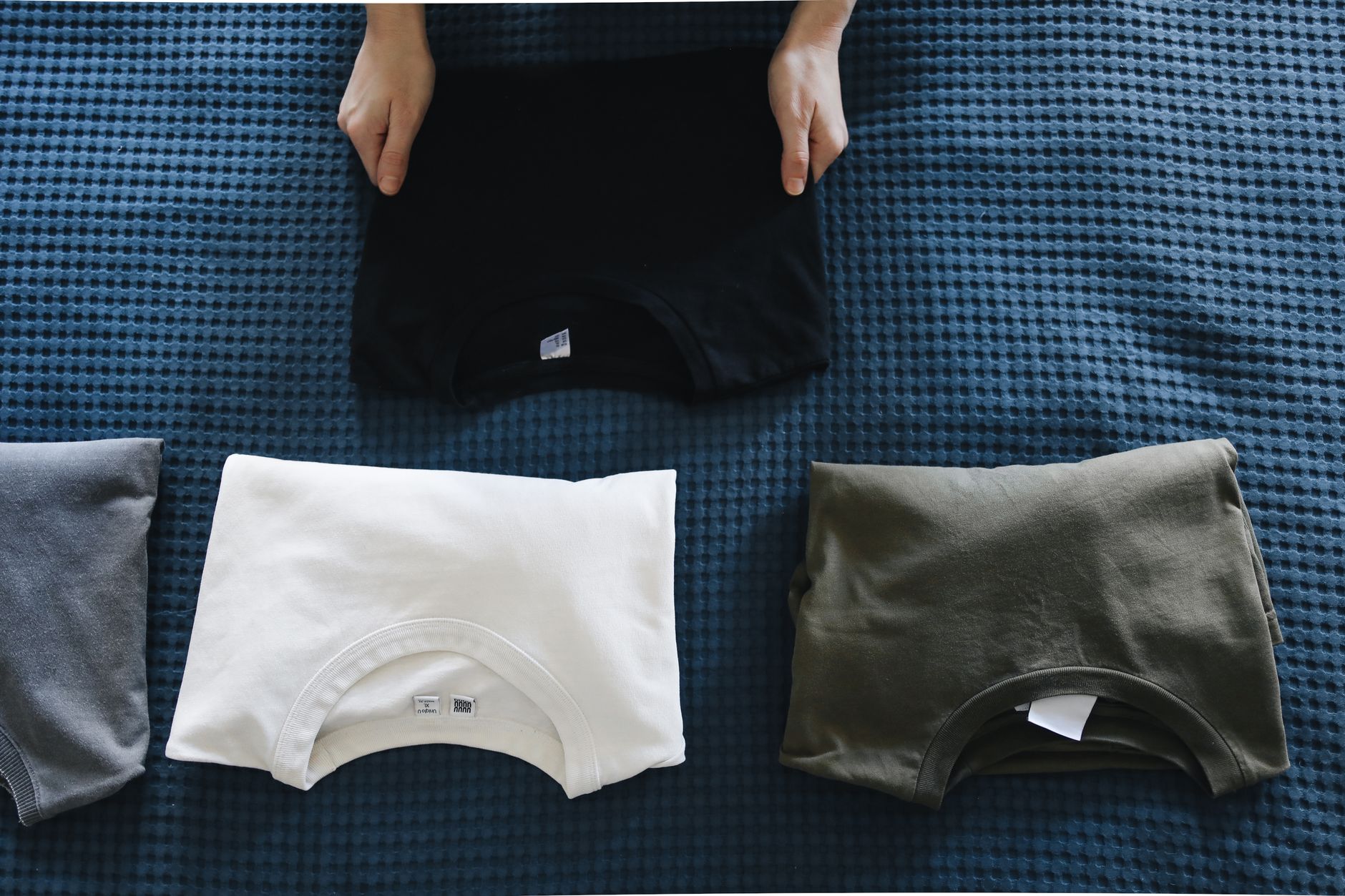 Folded T-shirts on a blanket