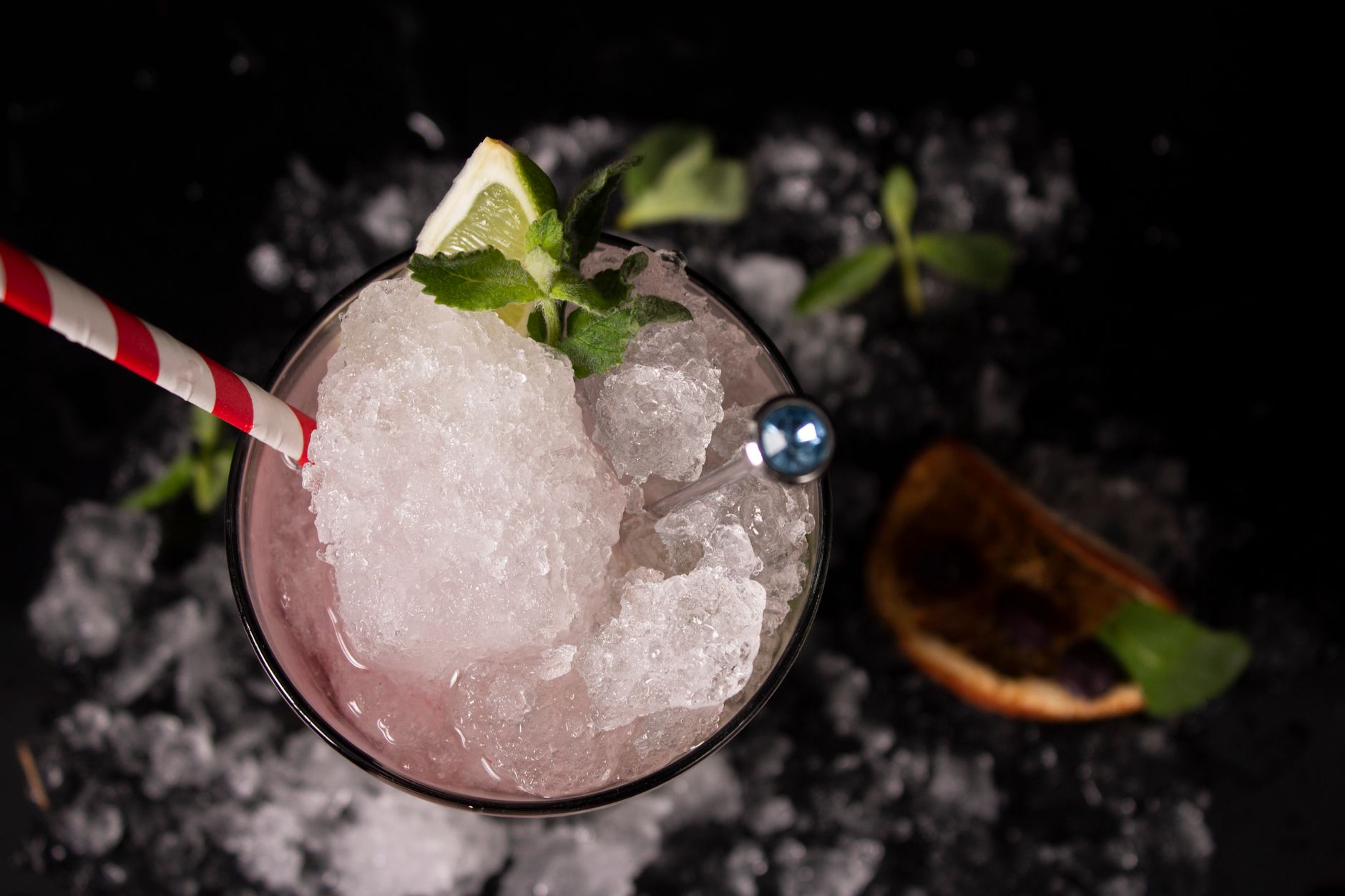 A cocktail poured over ice in a glass