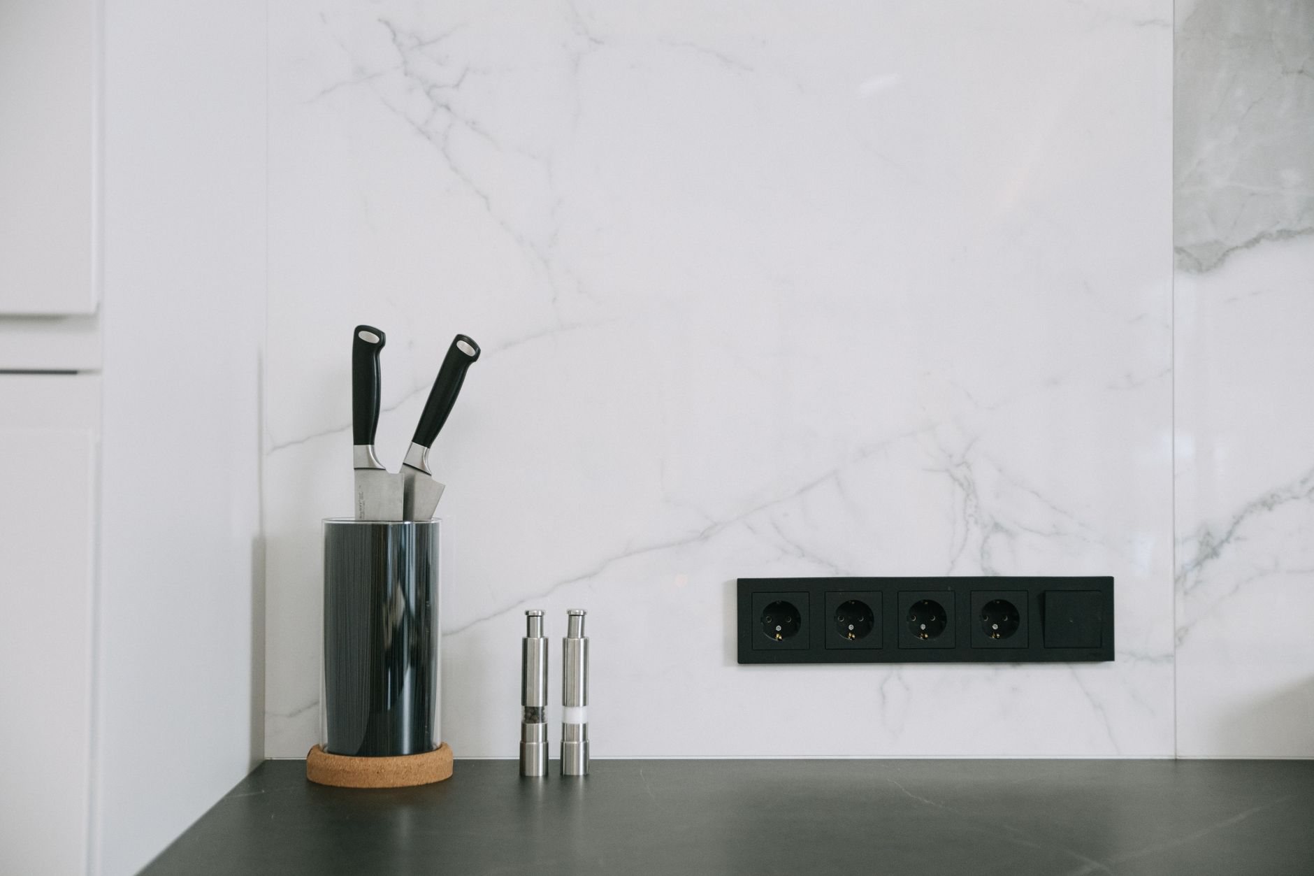 Kitchen counter with a wall outlet strip and knife block