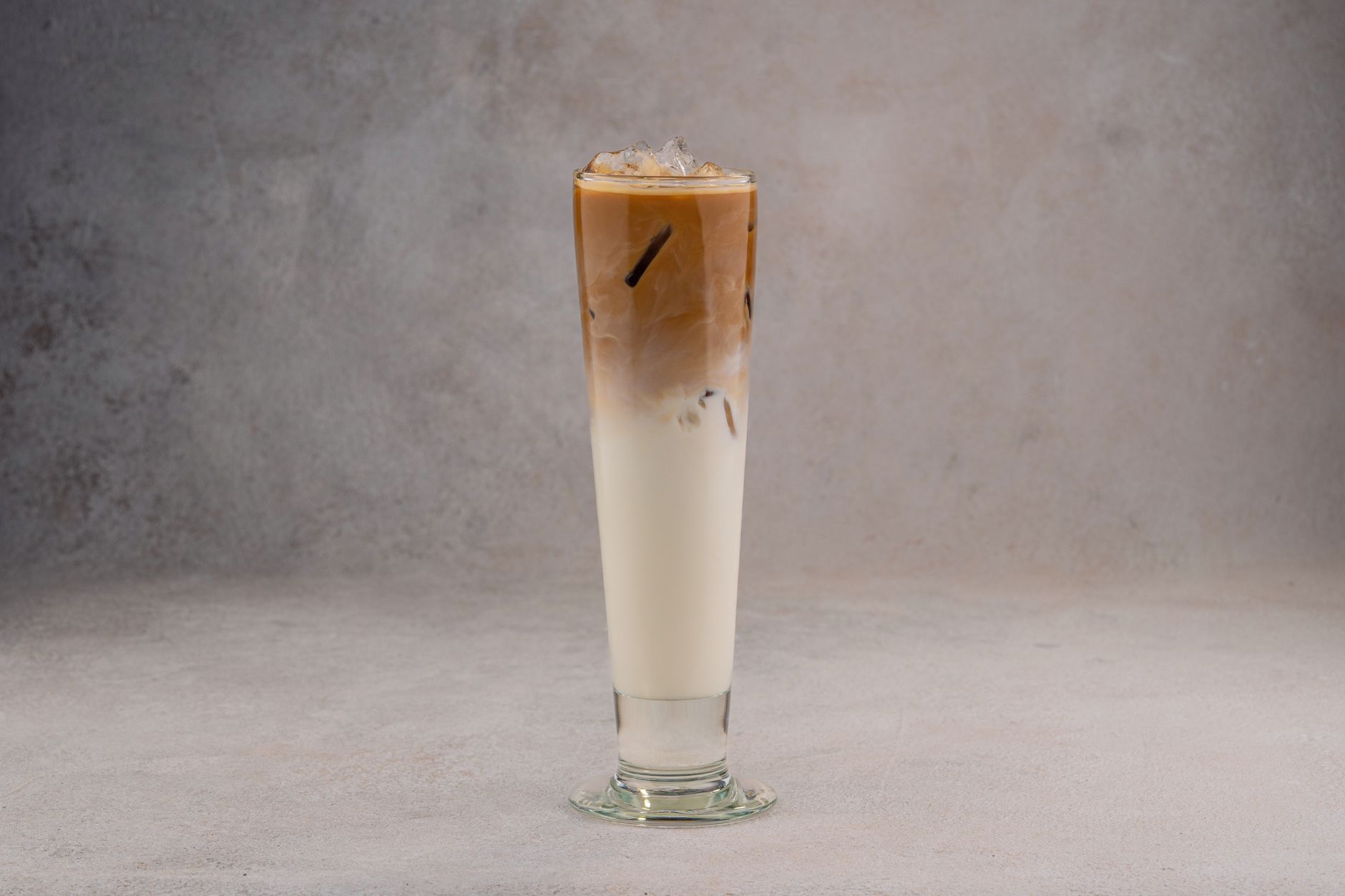 A layered iced coffee in a tall glass