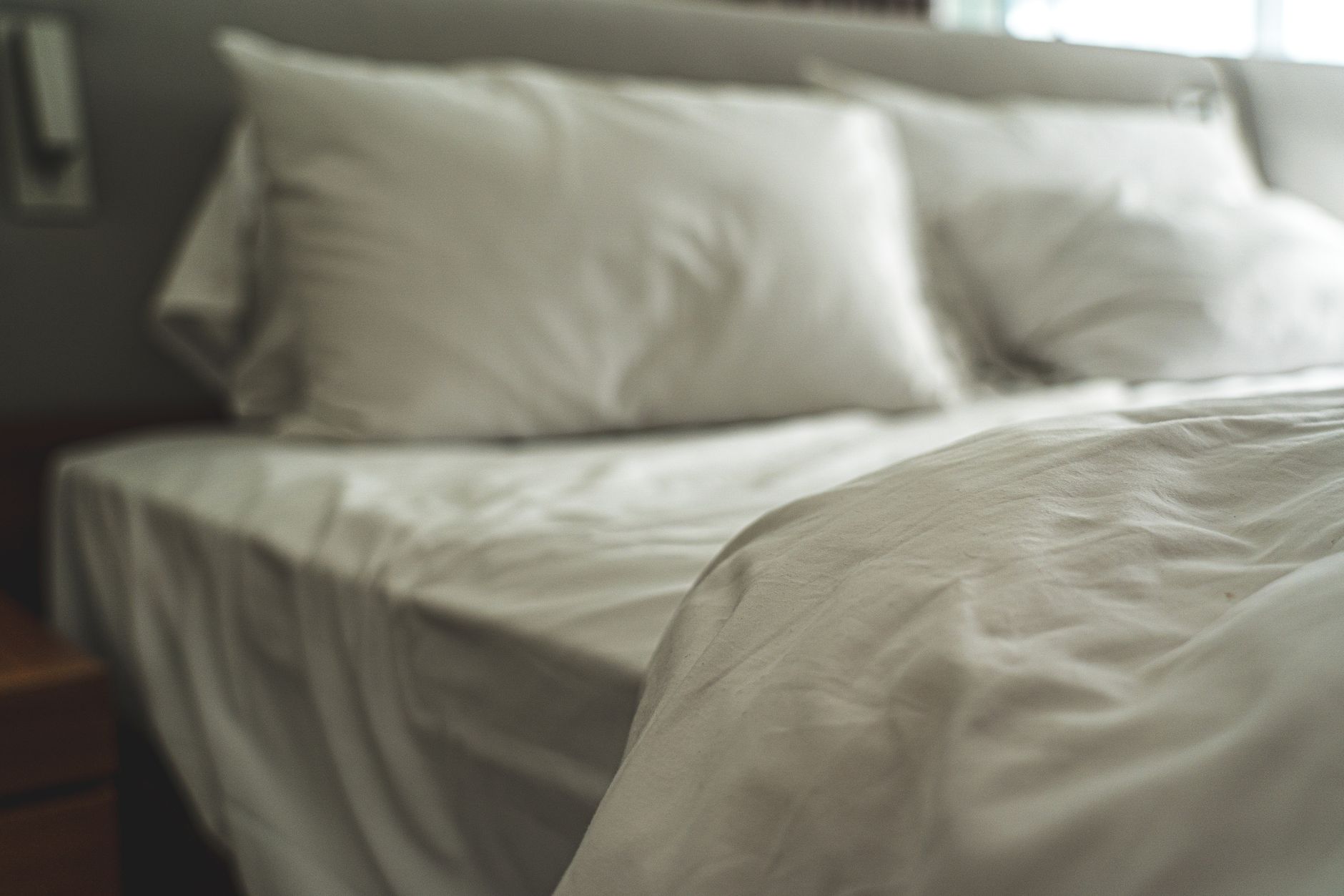 A made bed with white pillows